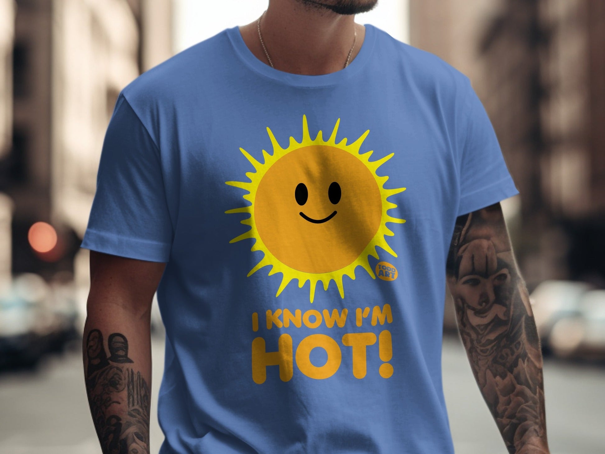 Blue t-shirt with a smiling sun graphic and text that reads "I KNOW I'M HOT!".