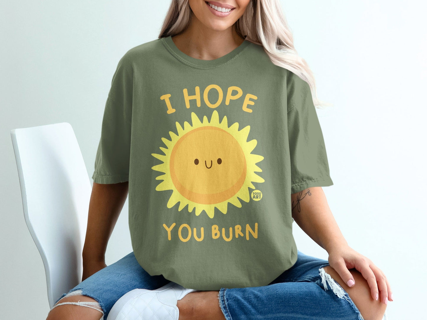 Green t-shirt with smiling sun graphic and text "I HOPE YOU BURN".