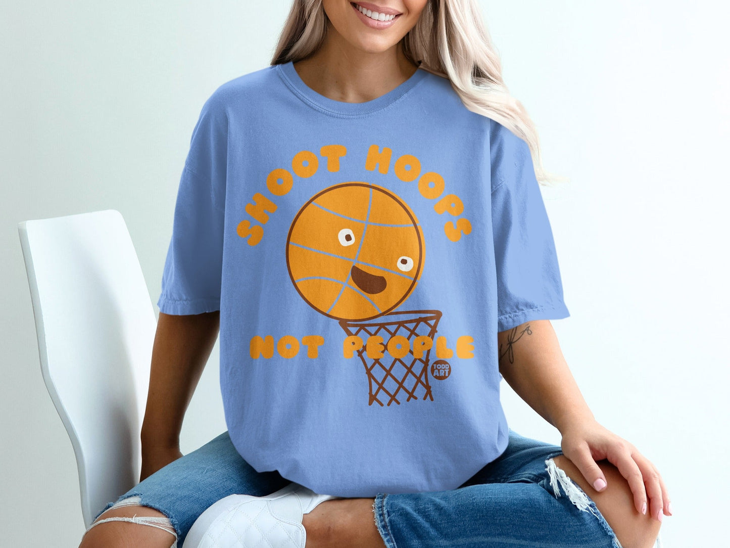Blue t-shirt with cartoon basketball shooting into a hoop.