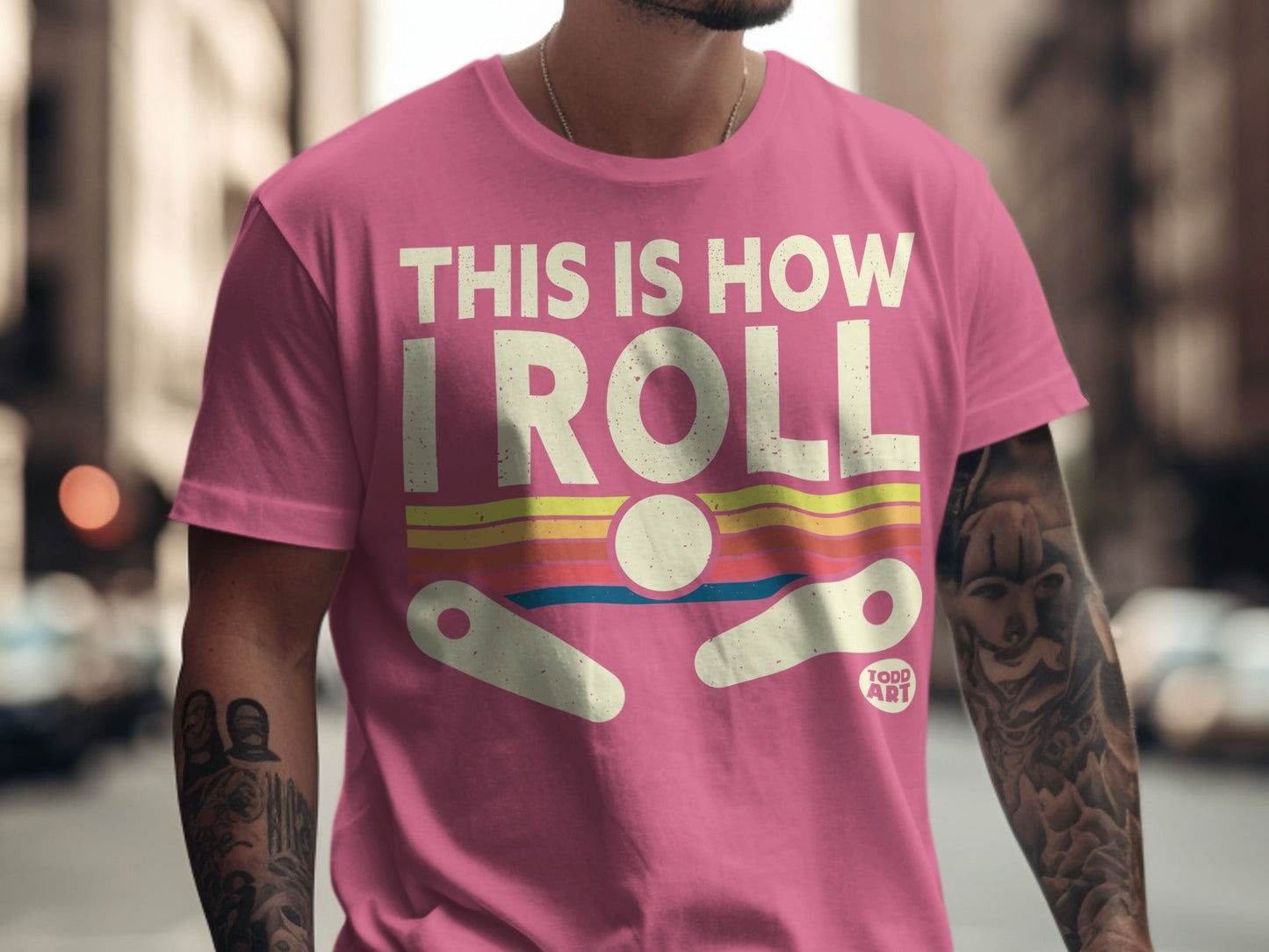 Pink t-shirt with "THIS IS HOW I ROLL" and pinball imagery.