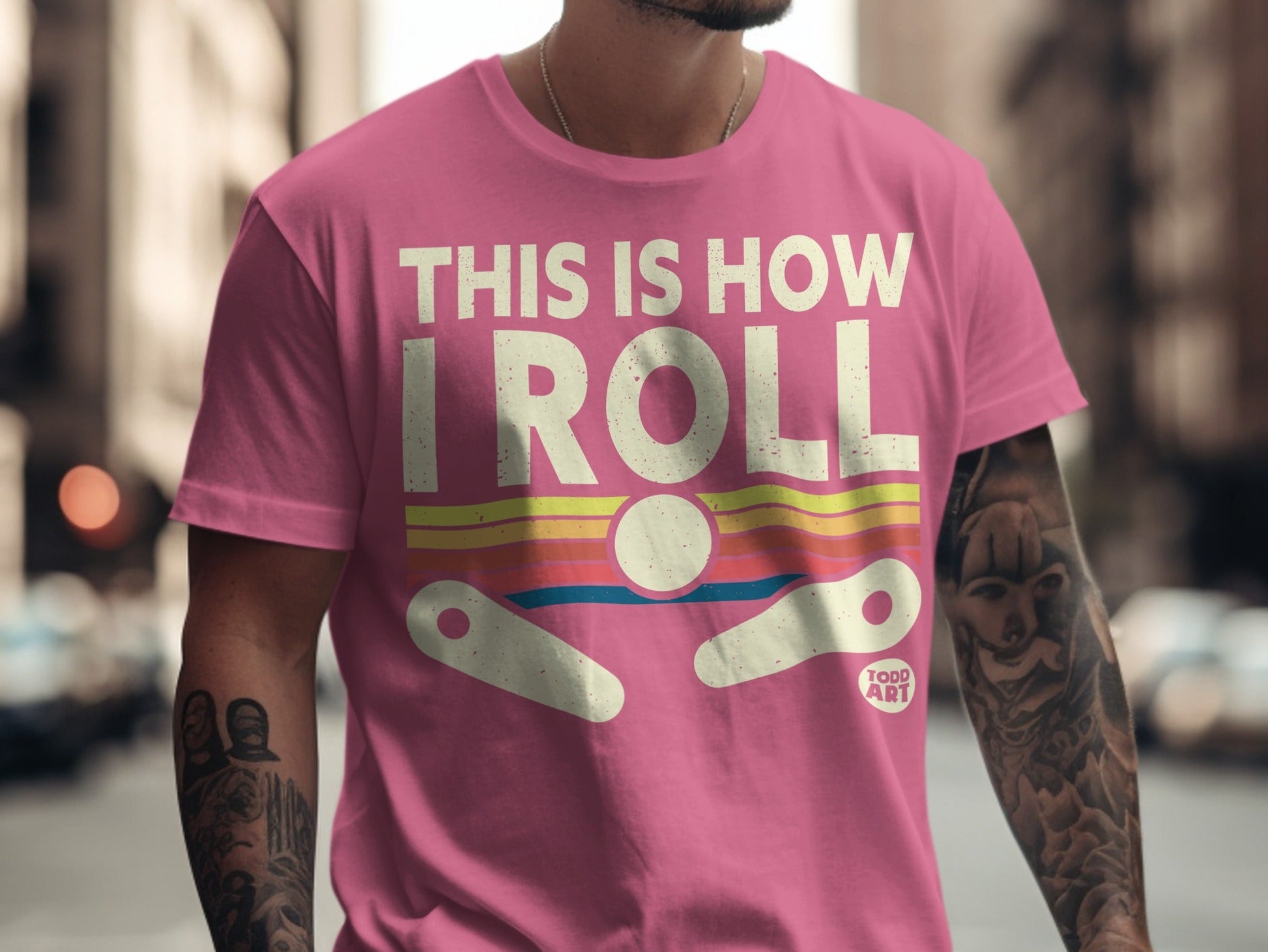 Pink t-shirt with "THIS IS HOW I ROLL" and pinball imagery.