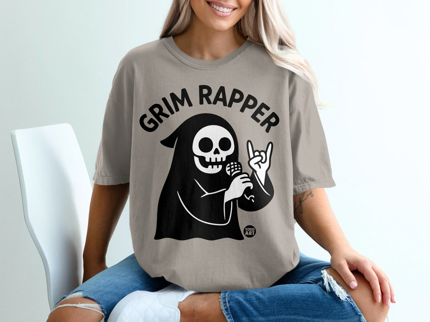Grim Rapper t-shirt with skull and microphone graphic.