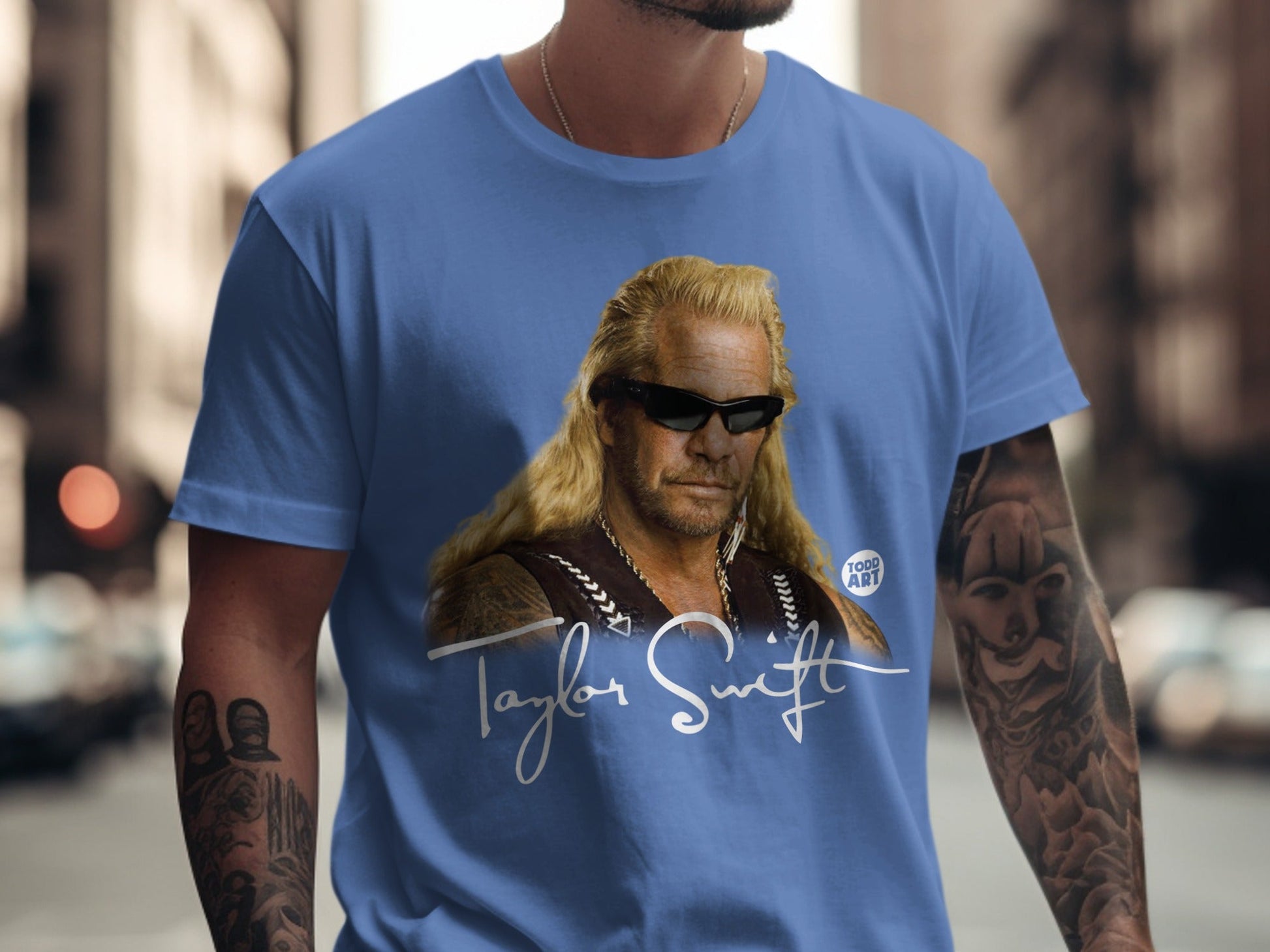 Blue t-shirt with a portrait of Dog the Bounty Hunter and "Taylor Swift" text.