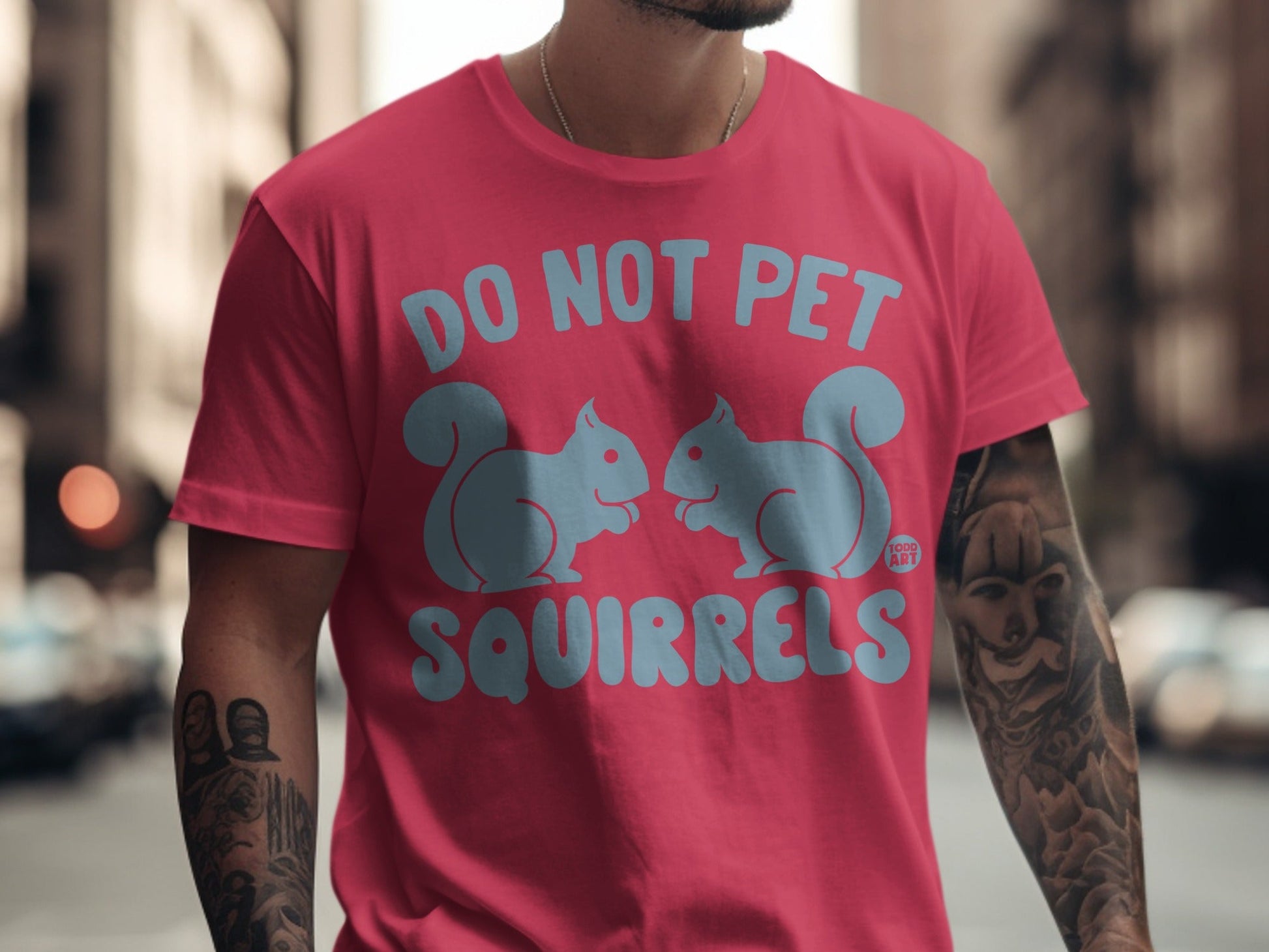 Pink t-shirt with "DO NOT PET SQUIRRELS" and two cartoon squirrels.