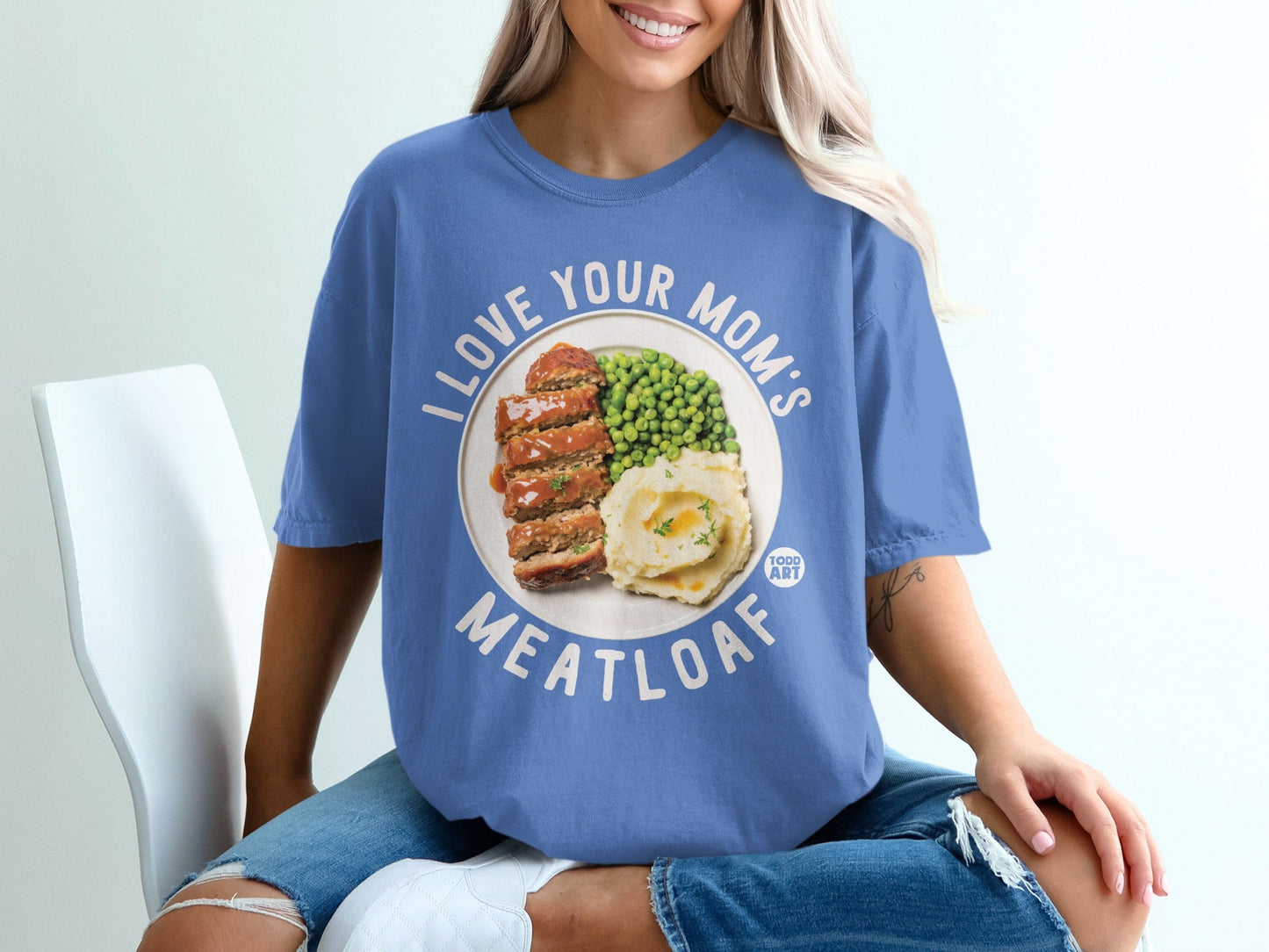 Blue t-shirt with circular graphic of meatloaf, mashed potatoes, and peas.