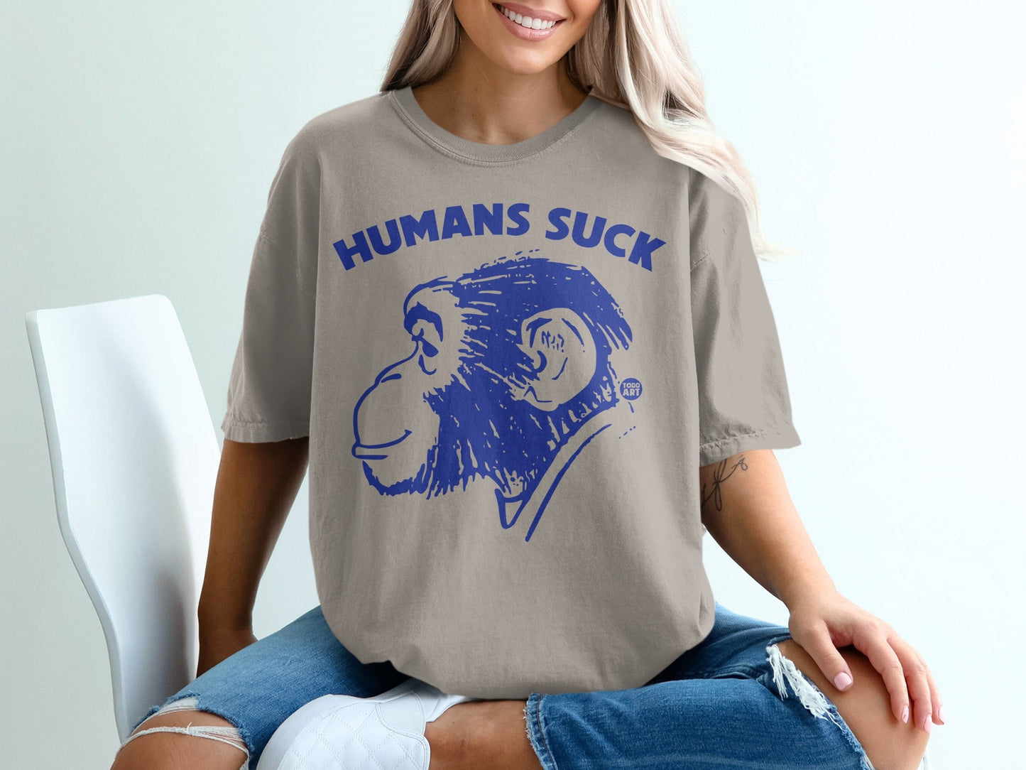 T-shirt with a blue monkey illustration and "HUMANS SUCK" text.