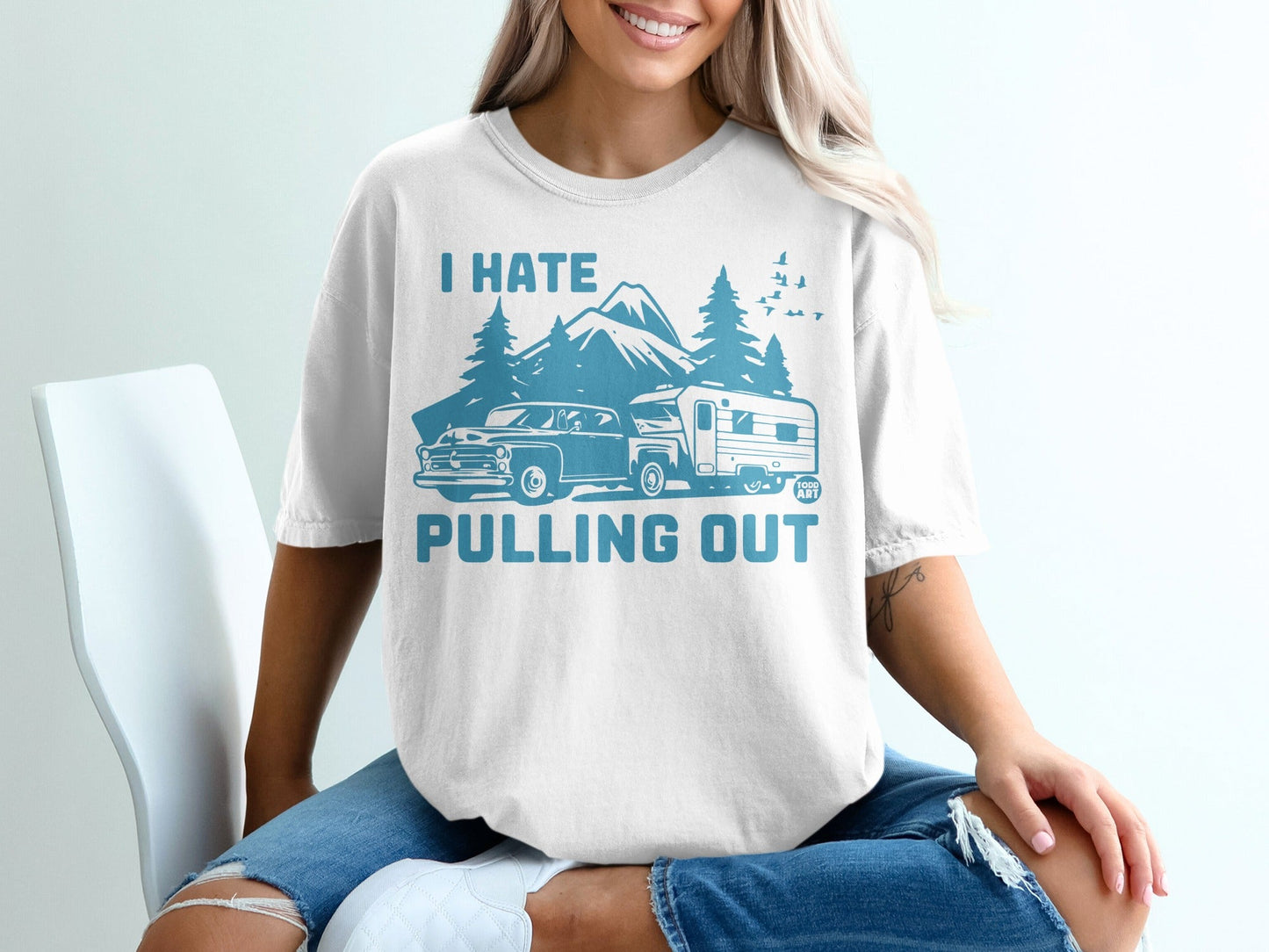 White t-shirt with "I hate pulling out" text, mountains, trees, and a camper trailer.