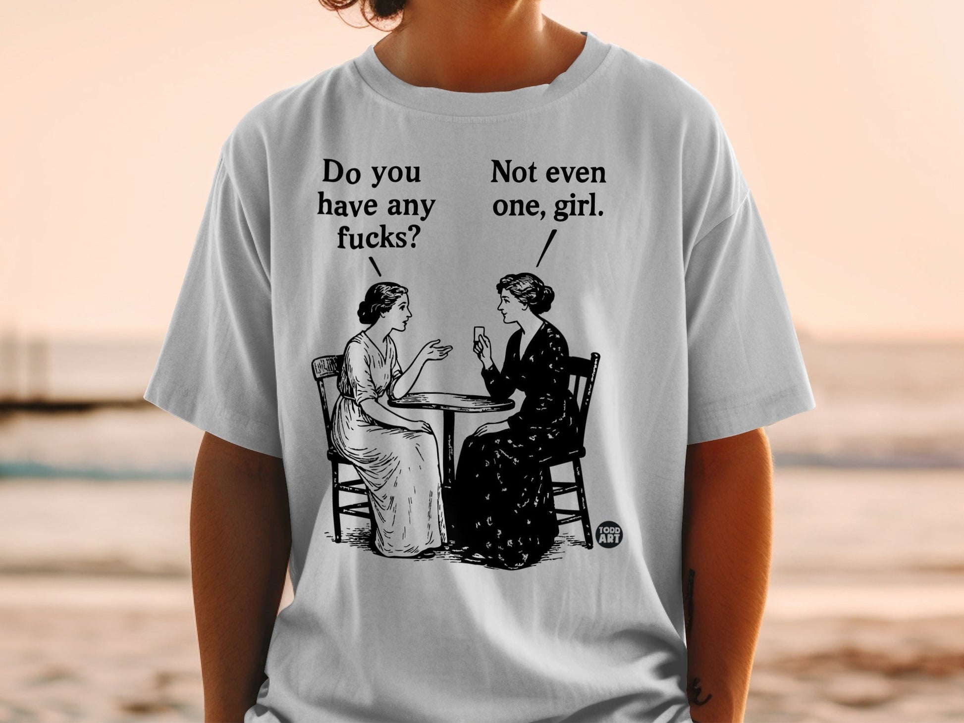 Two women sit at a table, one asking "Do you have any fucks?".