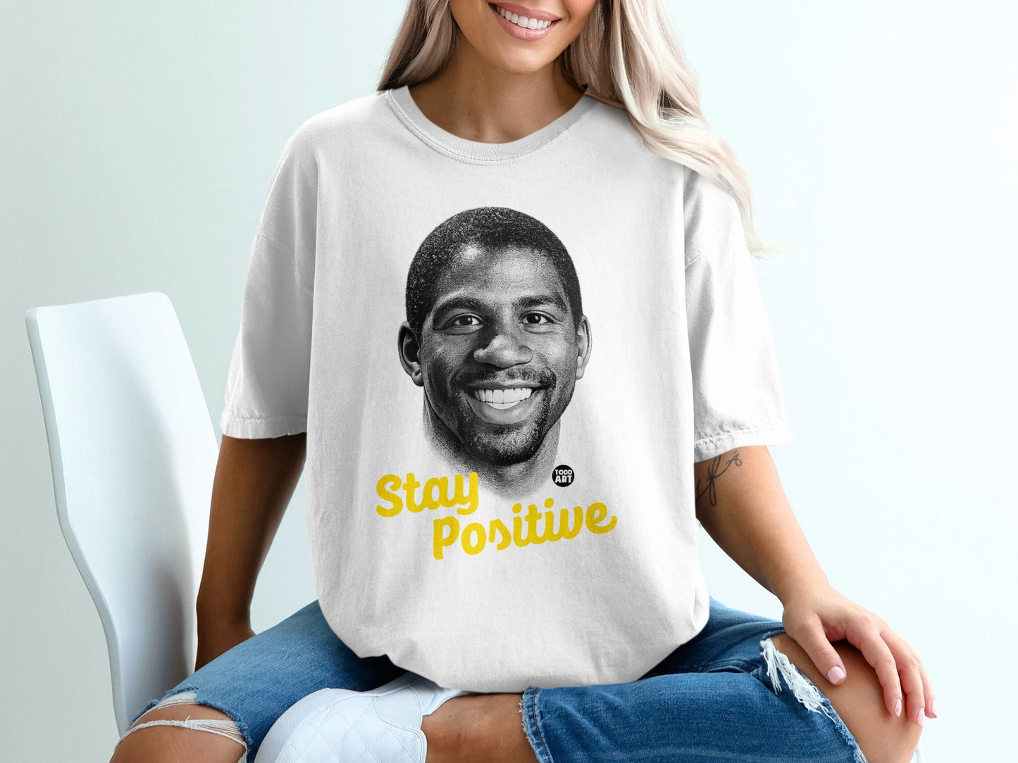 White t-shirt with Magic Johnson portrait and "Stay Positive" text.