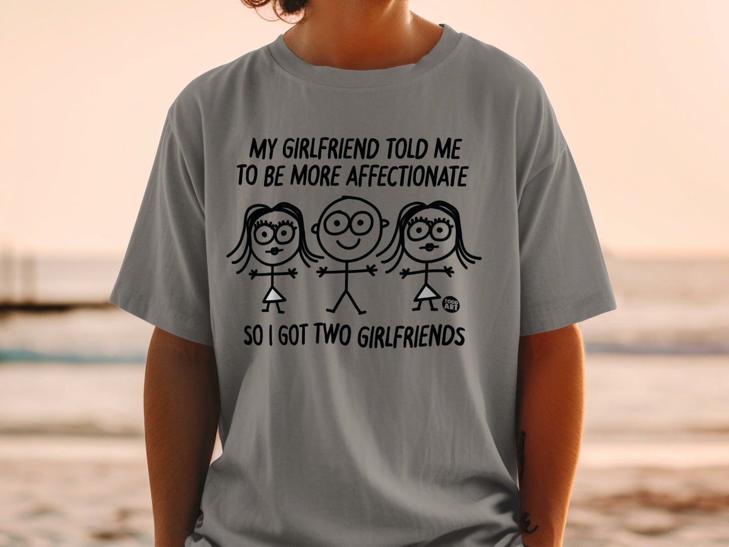 Gray t-shirt with text "My girlfriend told me to be more affectionate so I got two girlfriends."