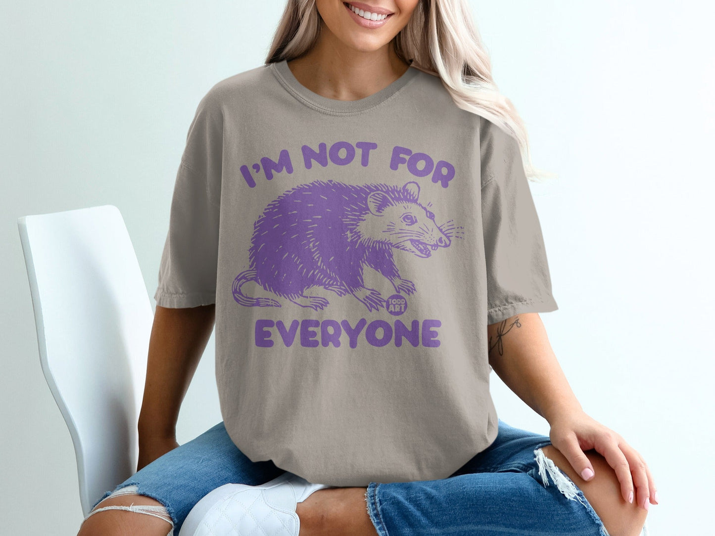 Beige t-shirt with purple possum graphic and text "I'm Not For Everyone".