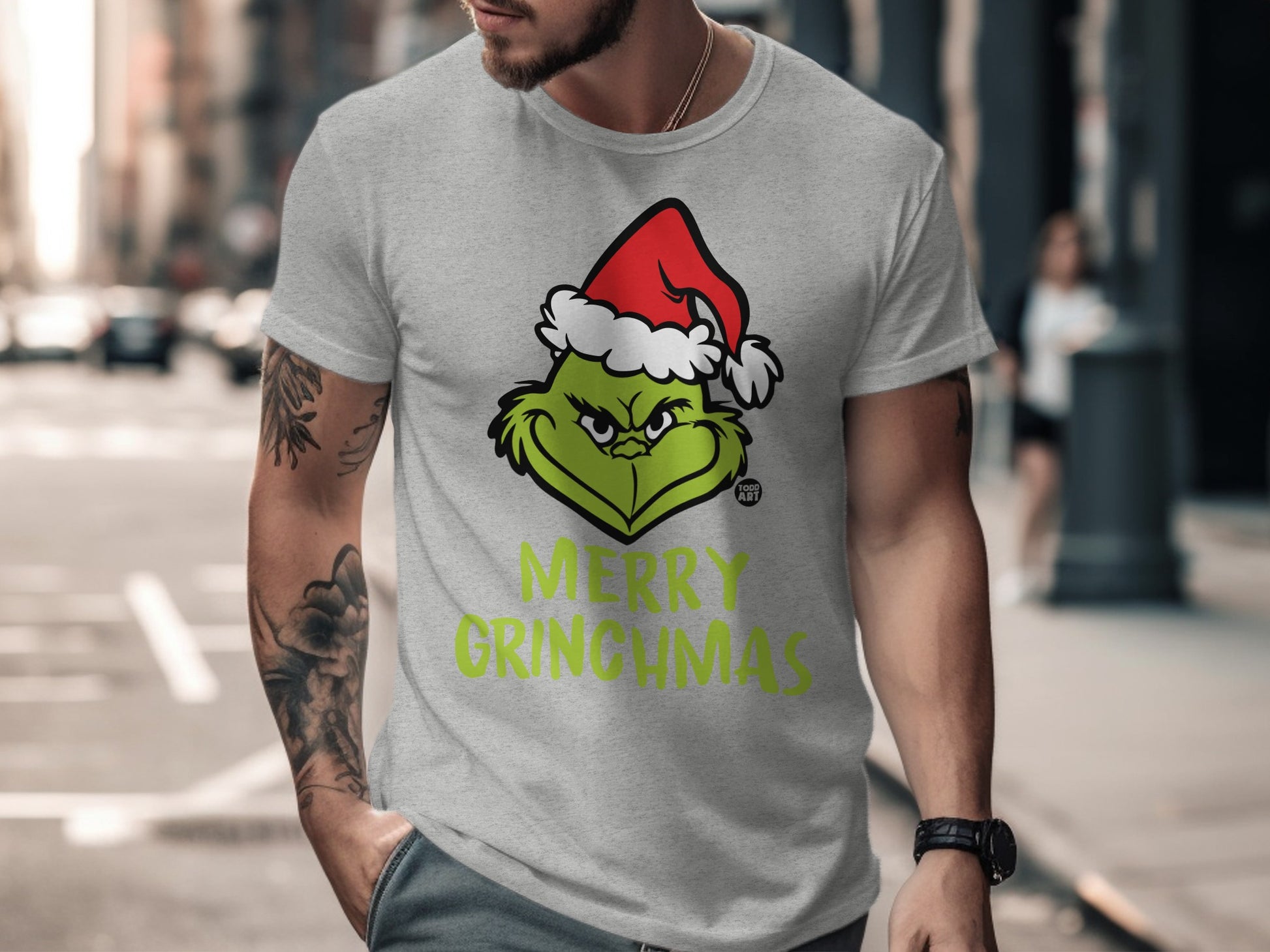 Merry Grinchmas graphic T-shirt with Santa hat design