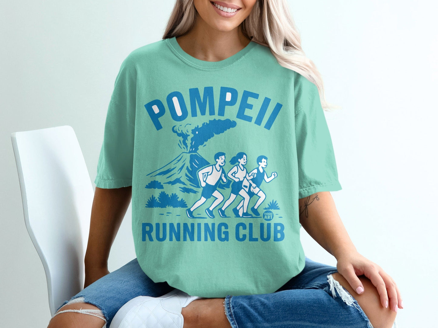 Teal t-shirt with "Pompeii Running Club" text and volcano graphic.