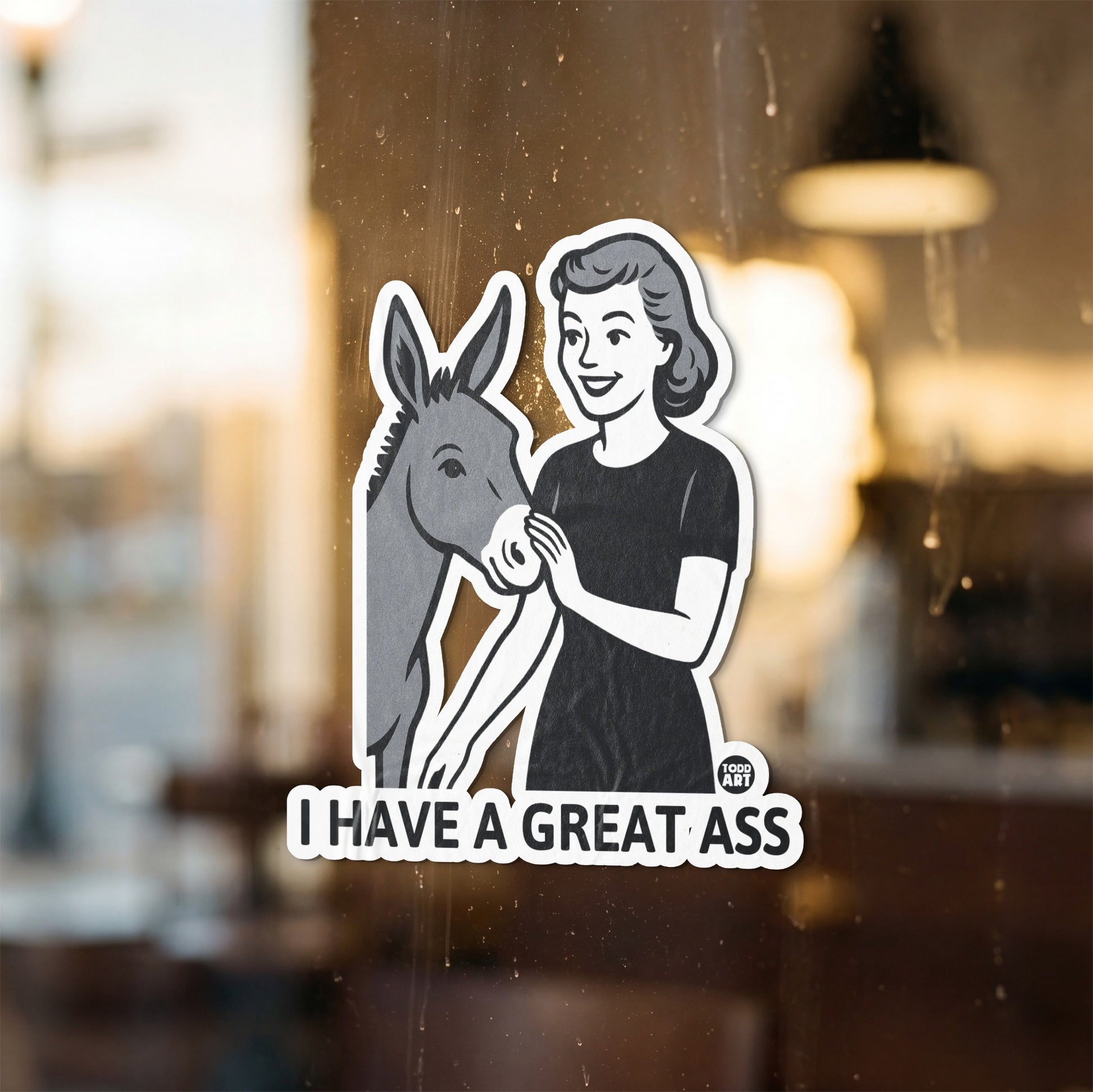 Sticker of a woman holding a donkey and text that reads "I HAVE A GREAT ASS."