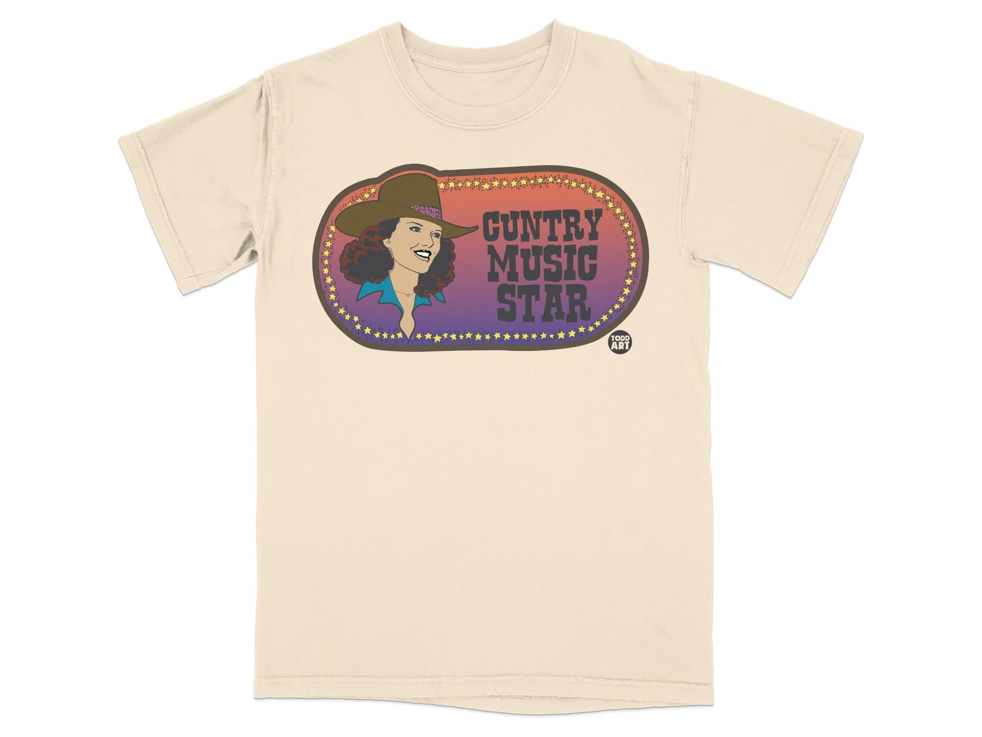 Country Music Star text and woman in cowboy hat on cream t-shirt.