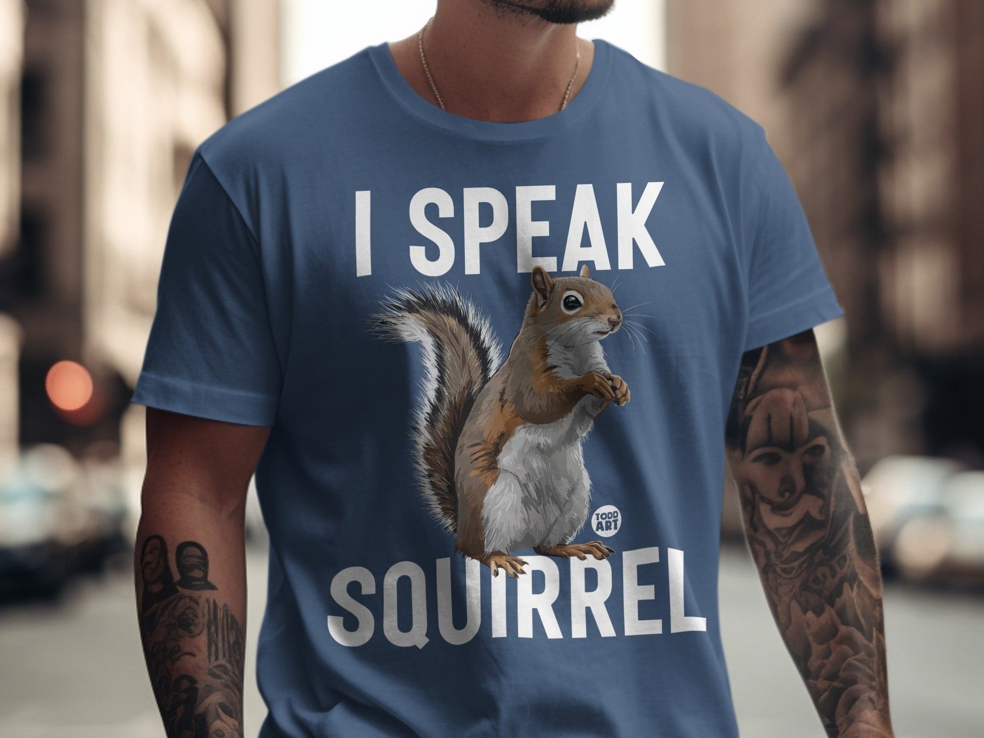 Blue t-shirt with "I SPEAK SQUIRREL" text and a squirrel graphic.