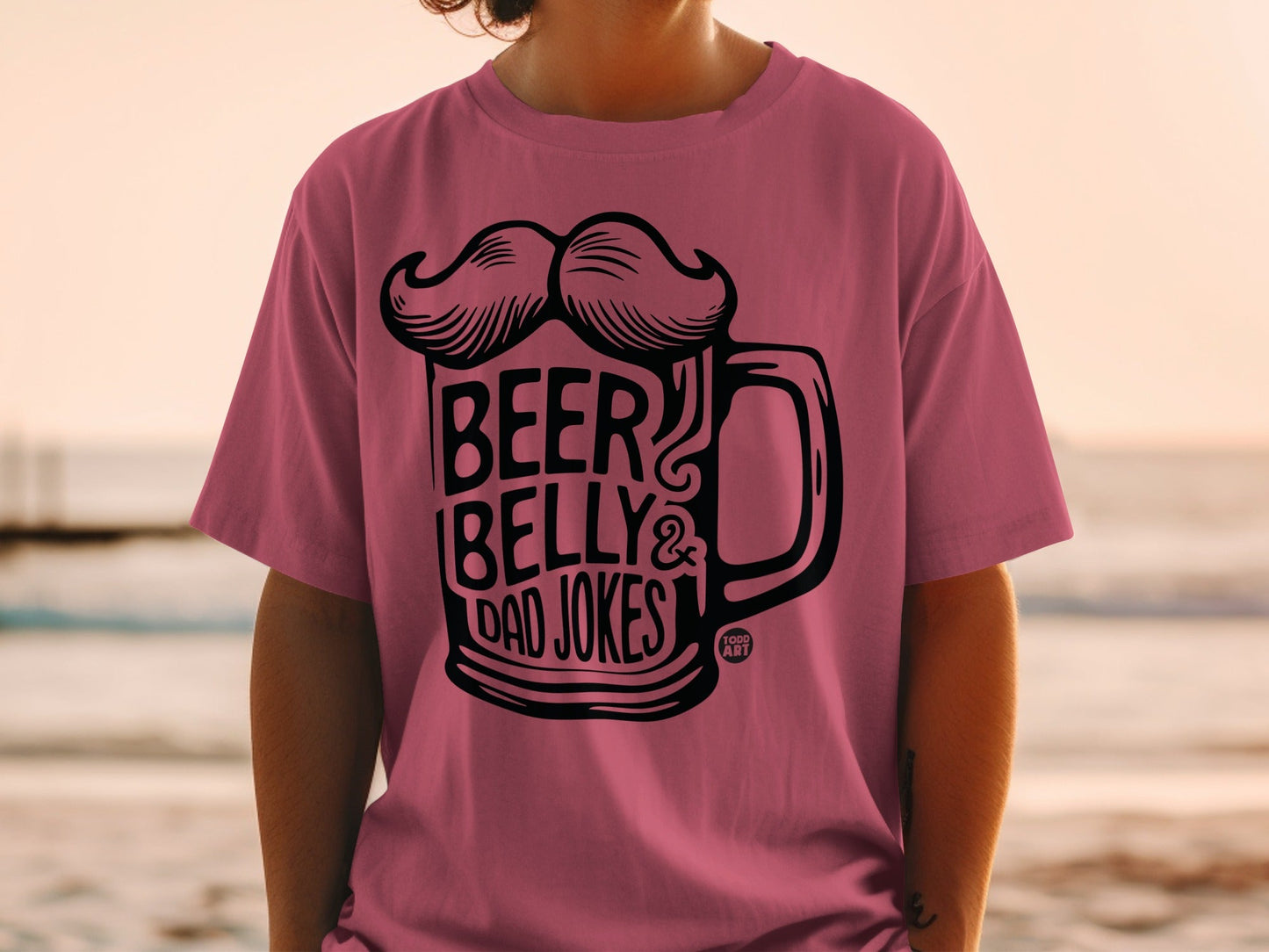 Pink t-shirt with "BEER BELLY & DAD JOKES" text and beer mug design.