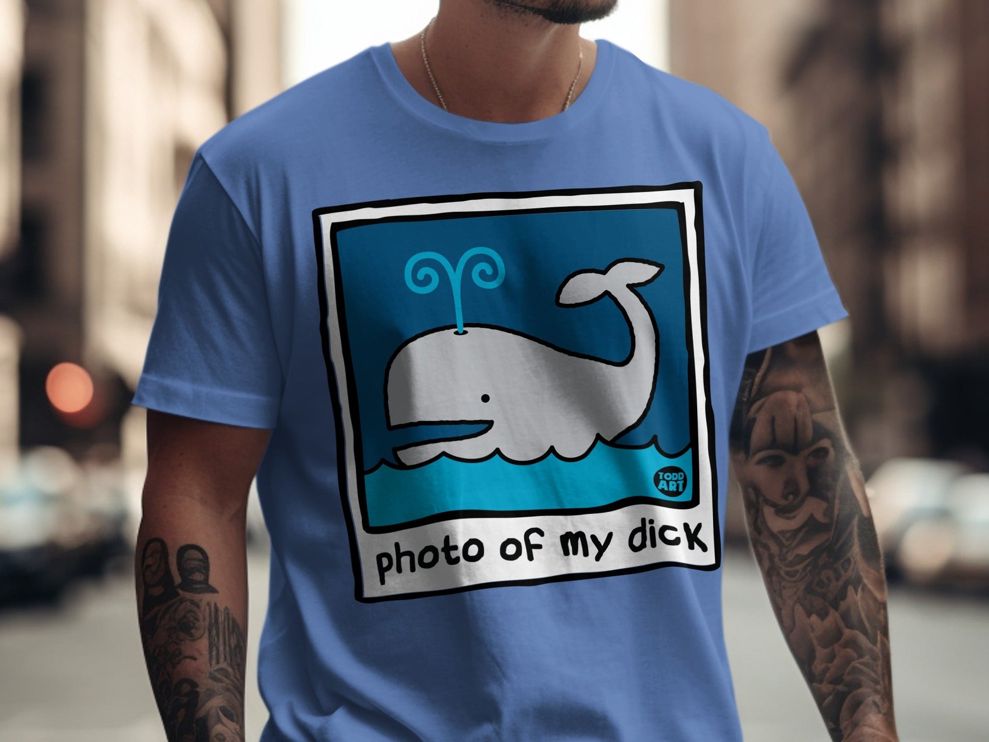 Blue t-shirt with whale illustration and "photo of my dick" text.