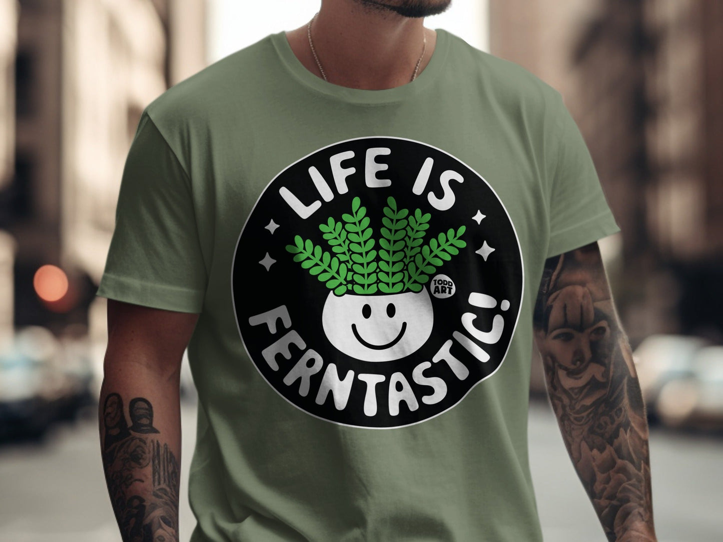 Green t-shirt with "Life is Fern-tastic!" graphic featuring a smiling potted fern.