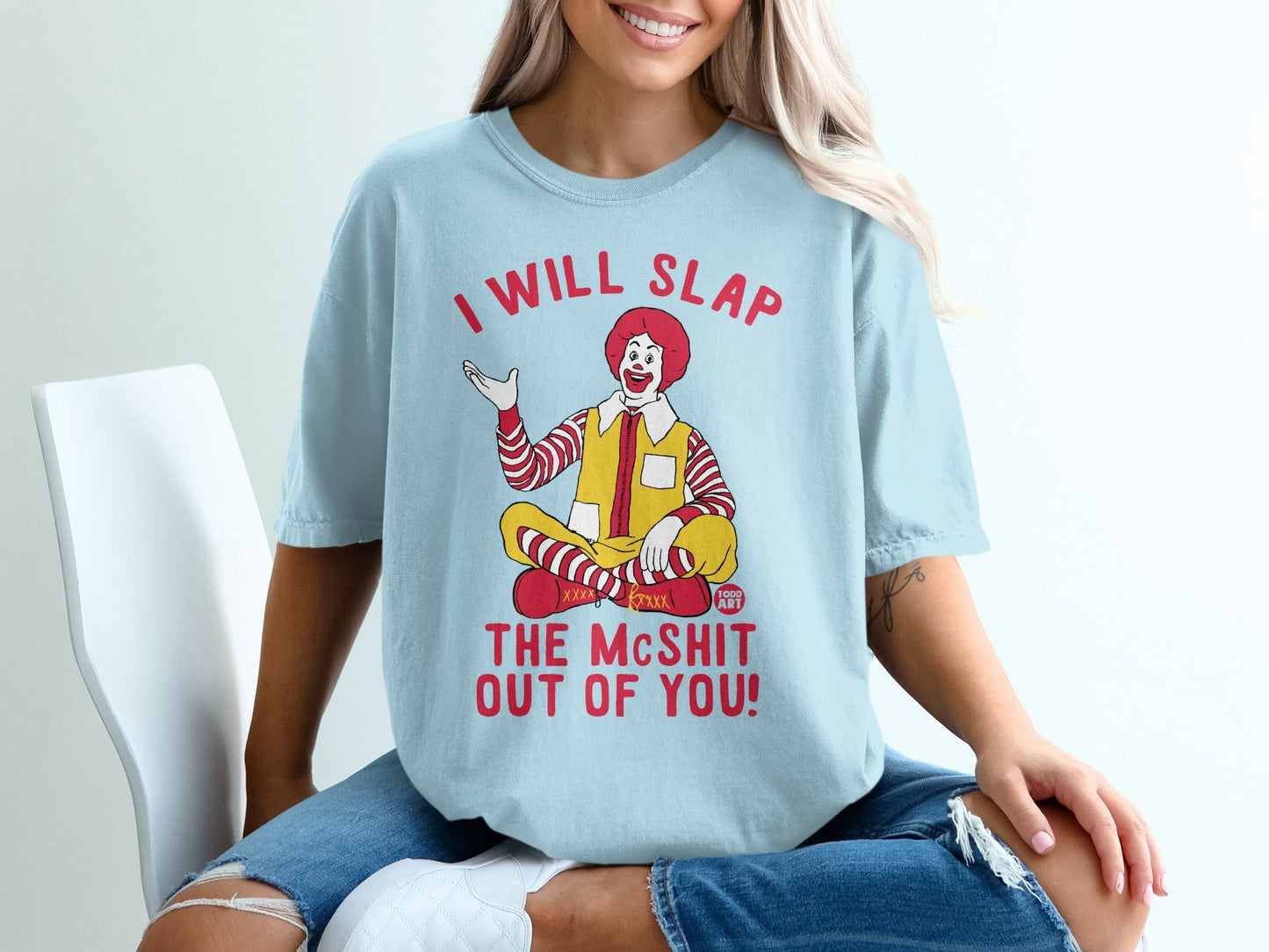 Light blue t-shirt with Ronald McDonald saying "I will slap the mcshit out of you!".