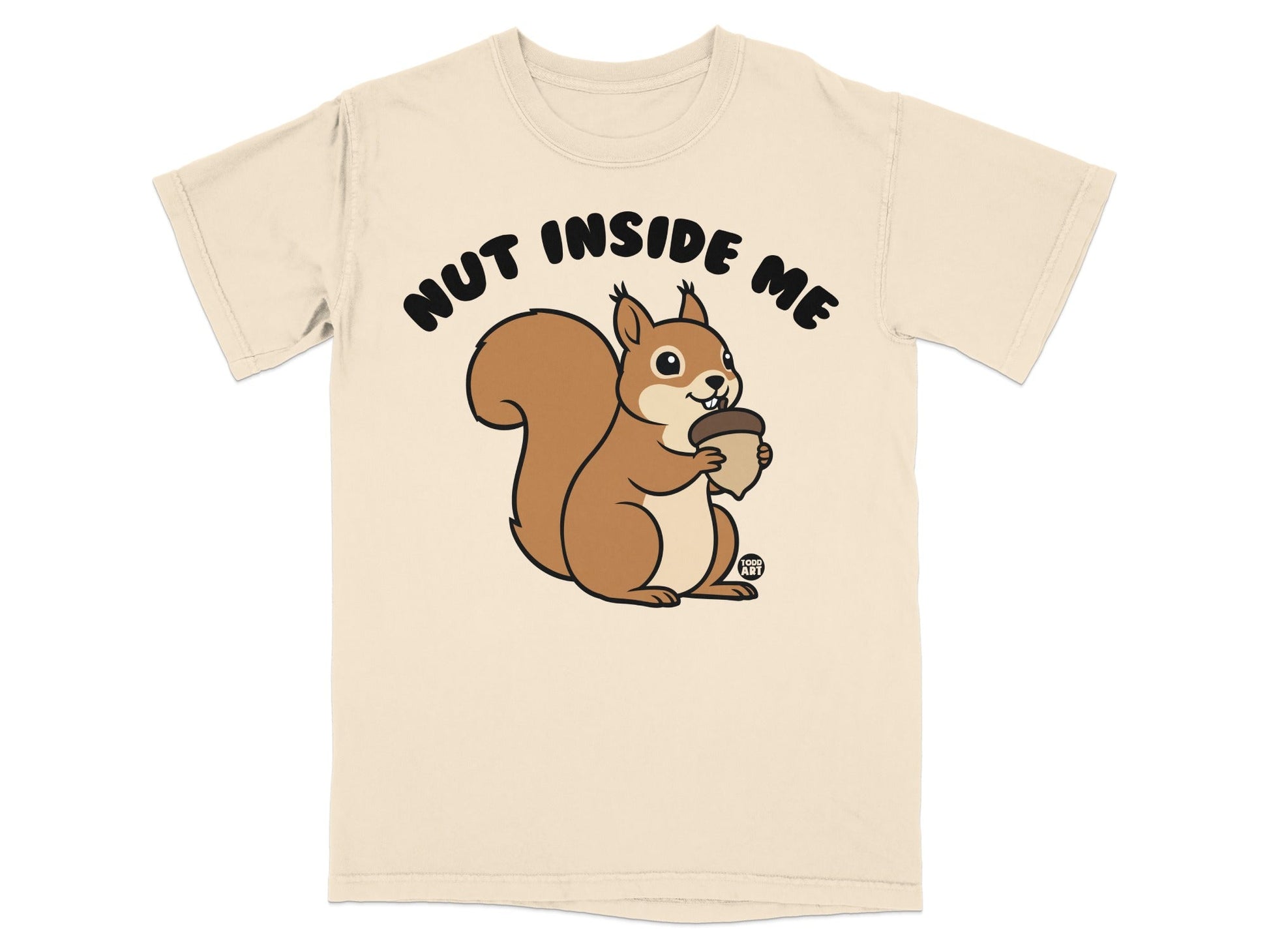 Squirrel holding acorn with "Nut Inside Me" text on a tan t-shirt.