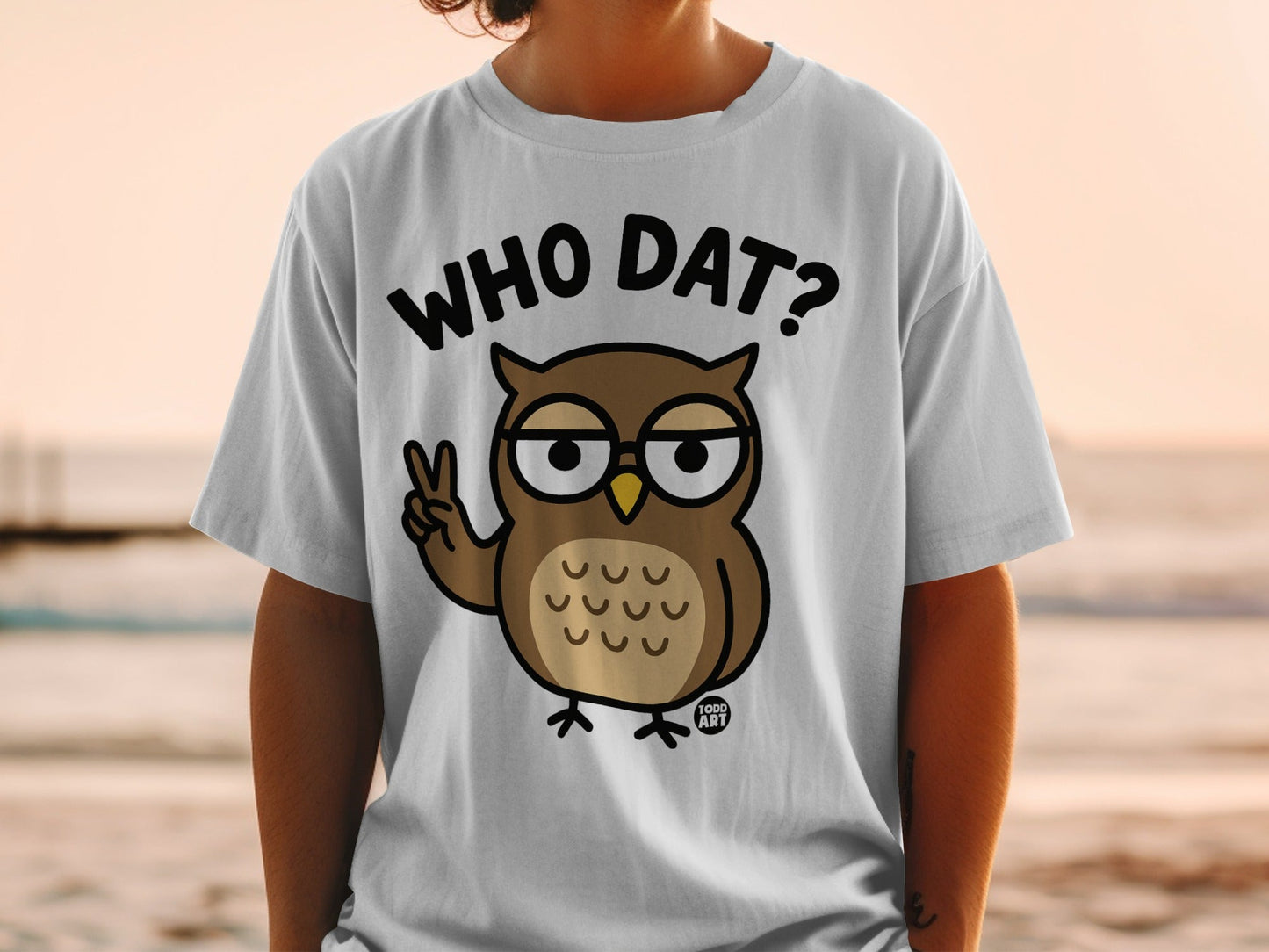 T-shirt with cartoon owl saying "Who Dat?" and giving a peace sign.