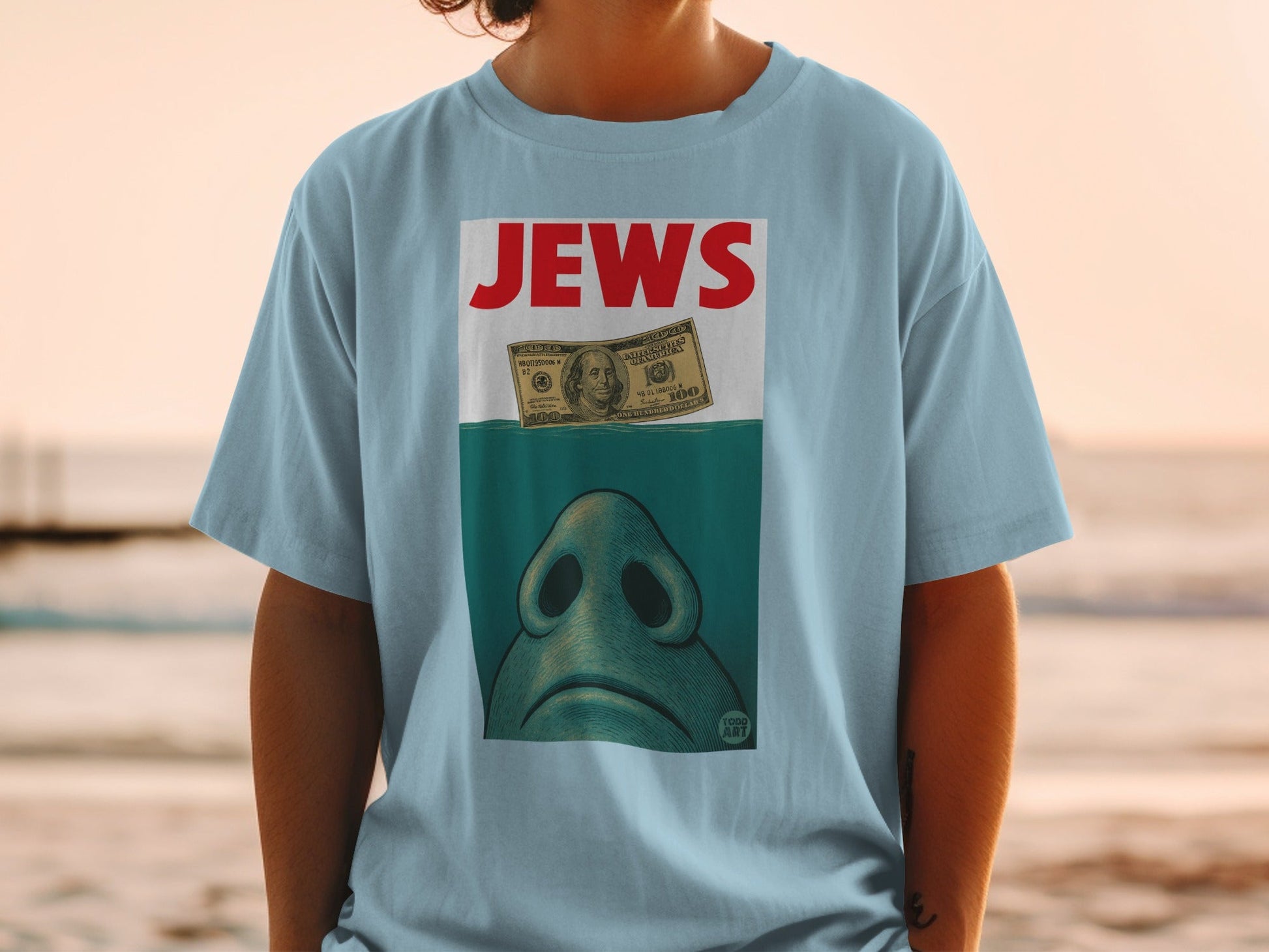 Light blue t-shirt with "JEWS" text and a shark fin over a hundred-dollar bill.