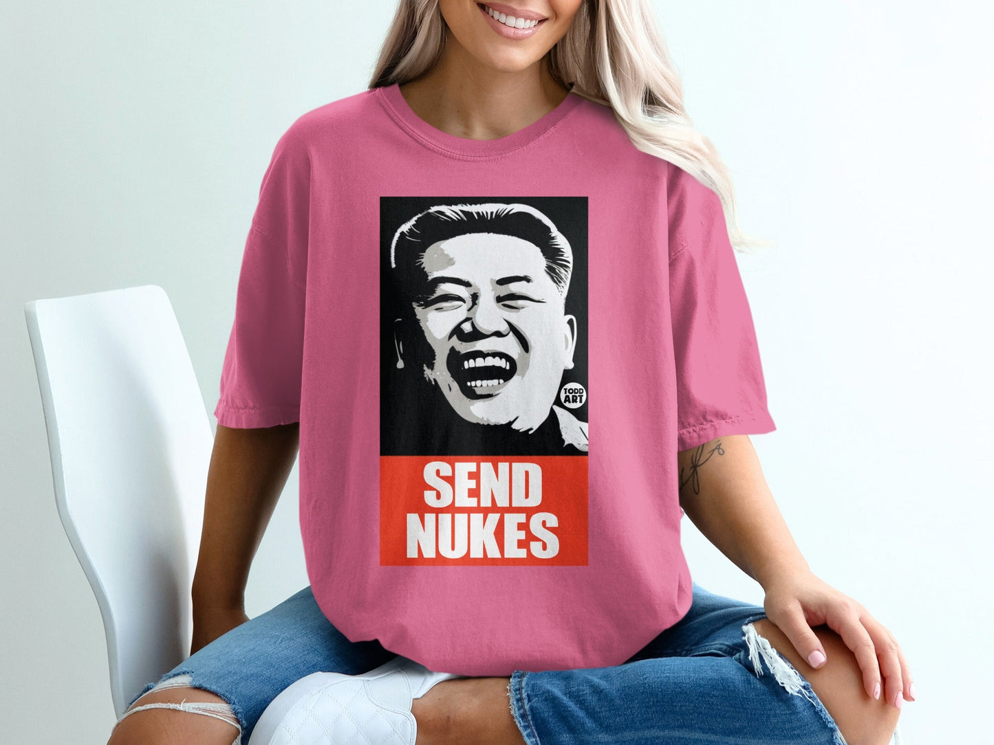 Pink t-shirt with a graphic of Kim Jong Un and the text "SEND NUKES."