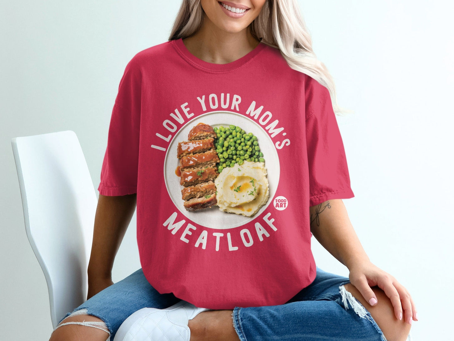 Pink t-shirt with text "I LOVE YOUR MOM'S MEATLOAF" and a graphic of meatloaf with peas and mashed potatoes.