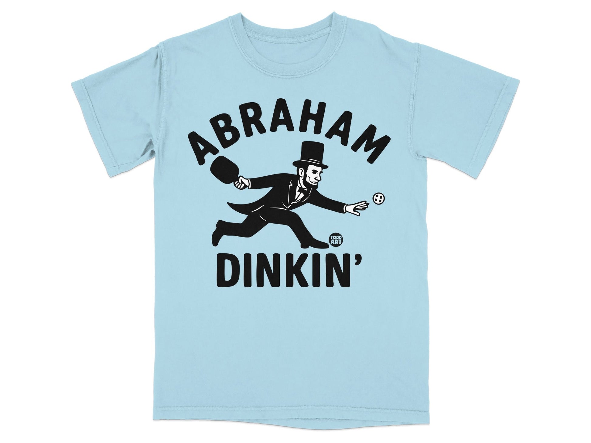 Abraham Lincoln playing pickleball in a hat and suit, text "ABRAHAM DINKIN'".