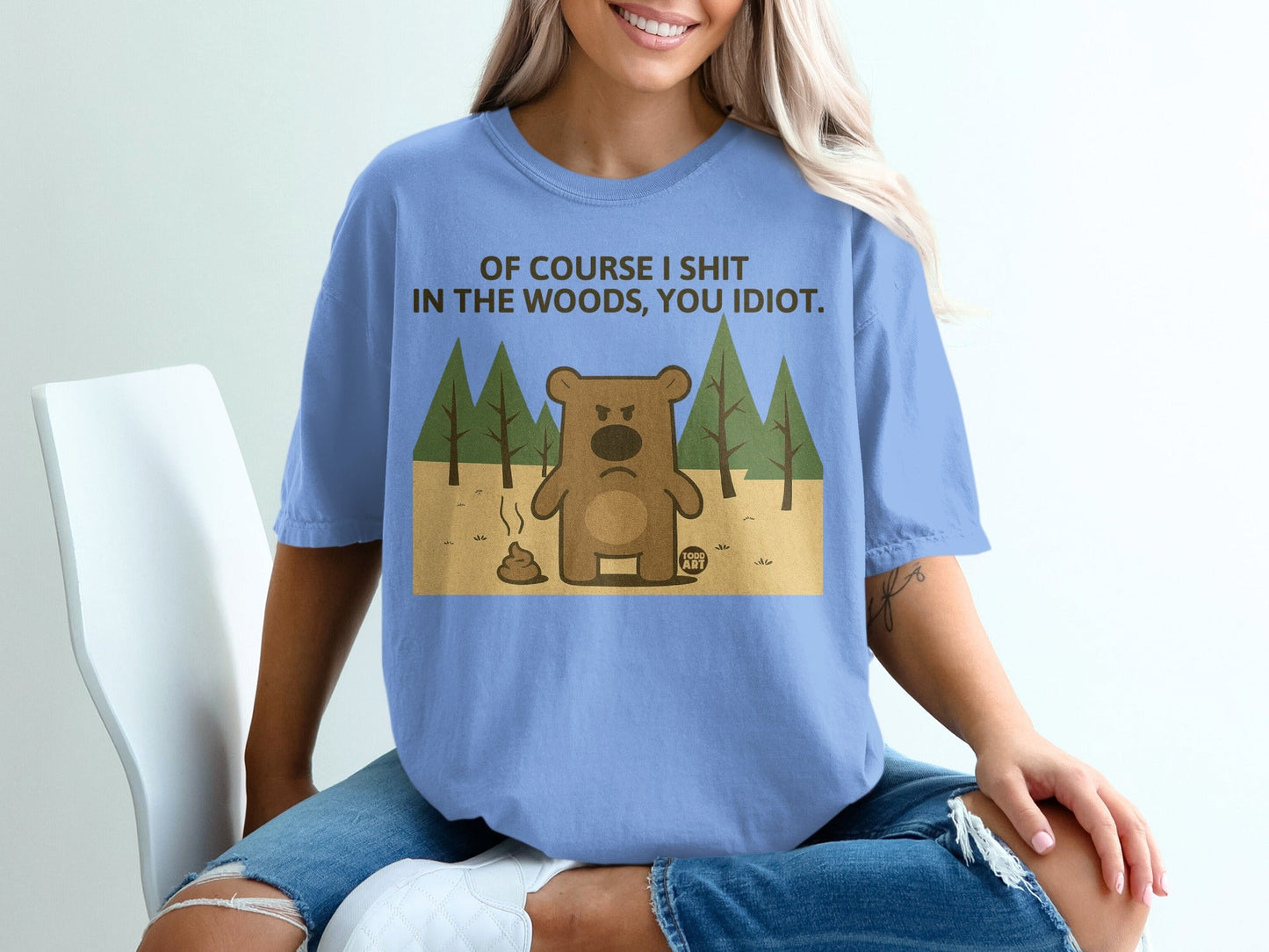 Blue t-shirt with cartoon bear and text: "OF COURSE I SHIT IN THE WOODS, YOU IDIOT."