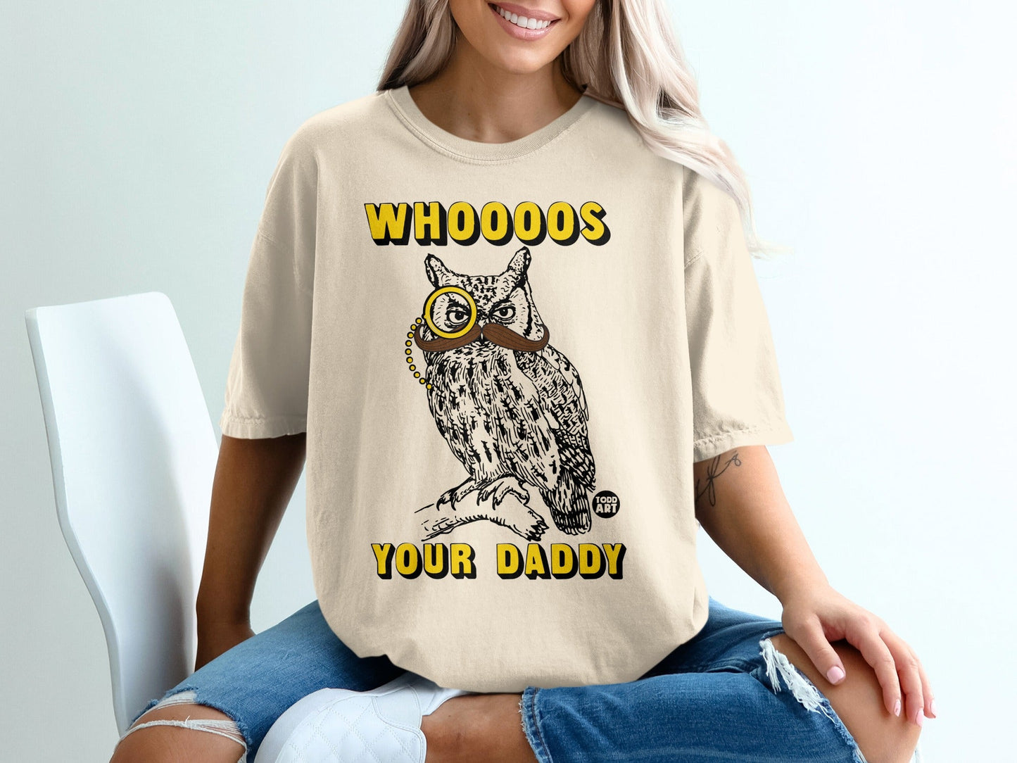 Cream t-shirt with owl wearing monocle and mustache, text "WHOOOOS YOUR DADDY".