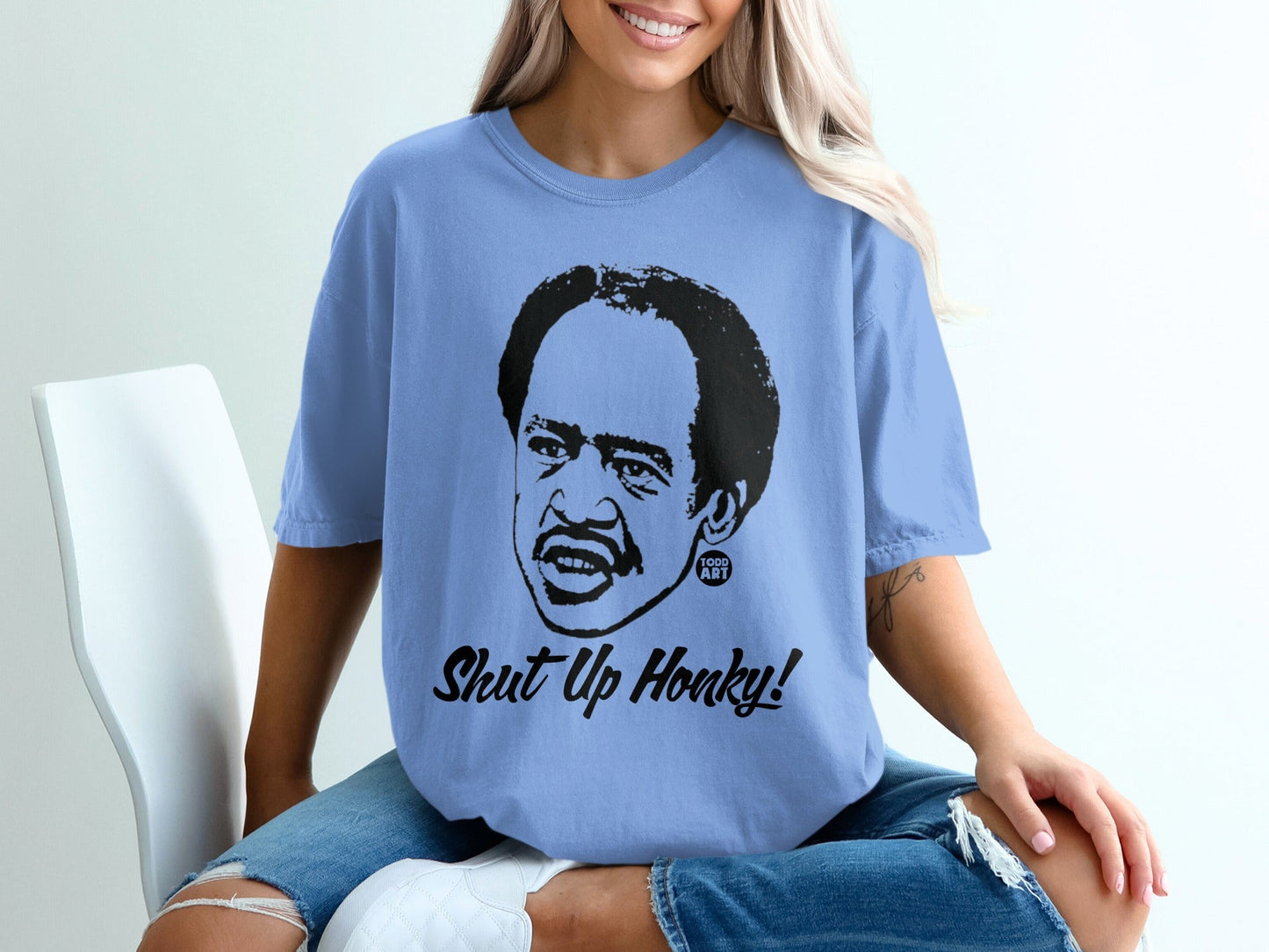 Light blue t-shirt with black graphic of Richard Pryor saying "Shut Up Honky!"