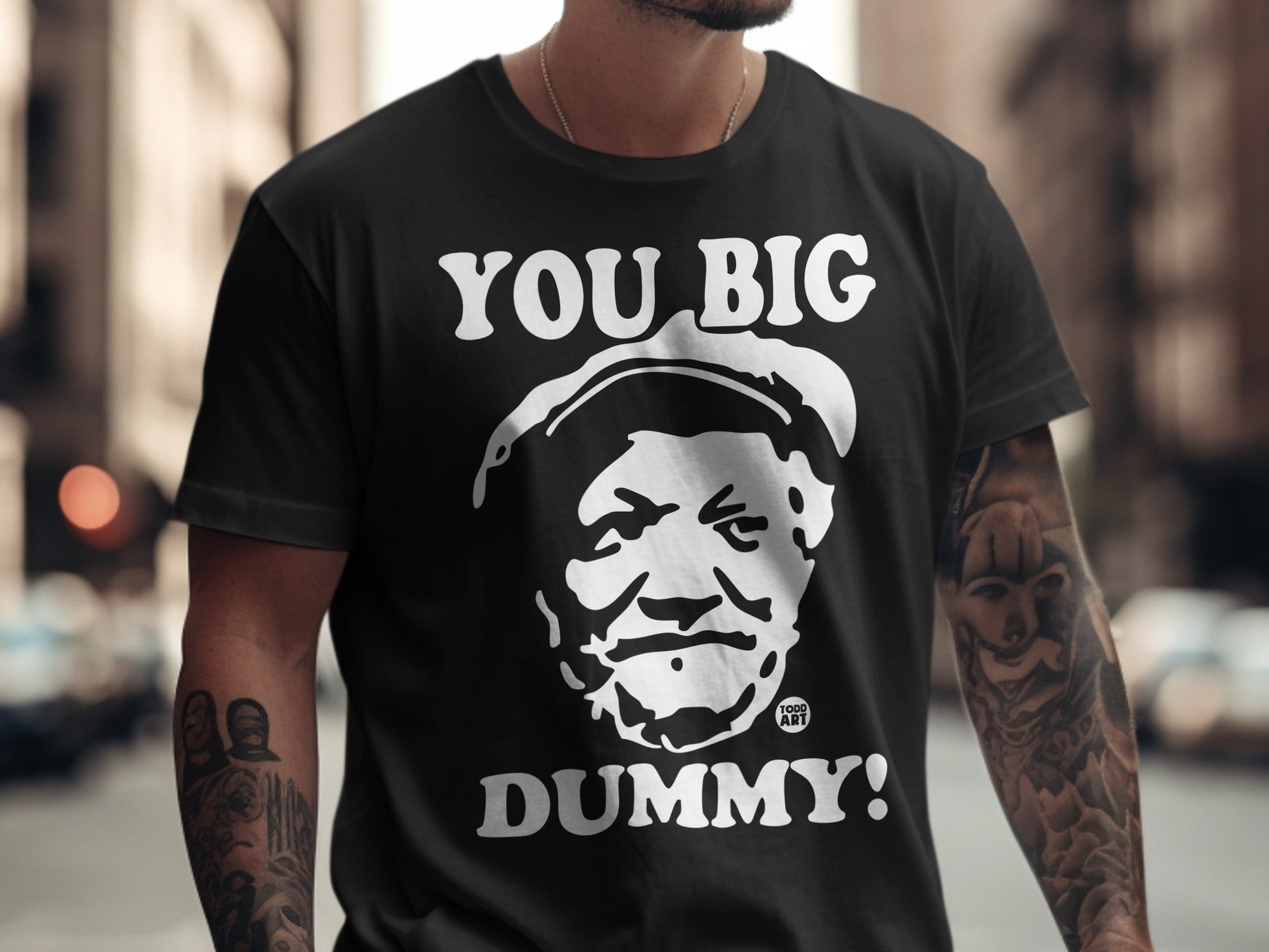 Black t-shirt with "YOU BIG DUMMY!" and a portrait of a man.