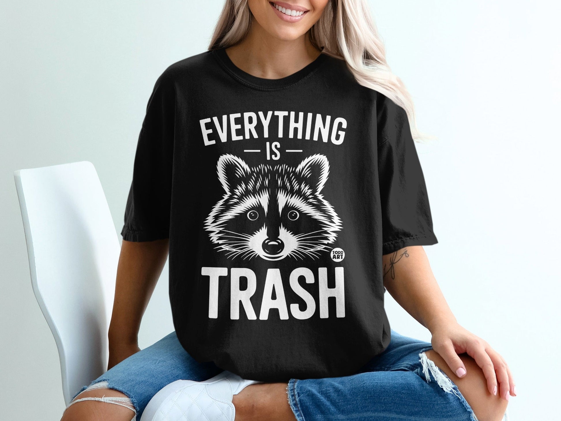Black t-shirt with a raccoon and "Everything is Trash" graphic.