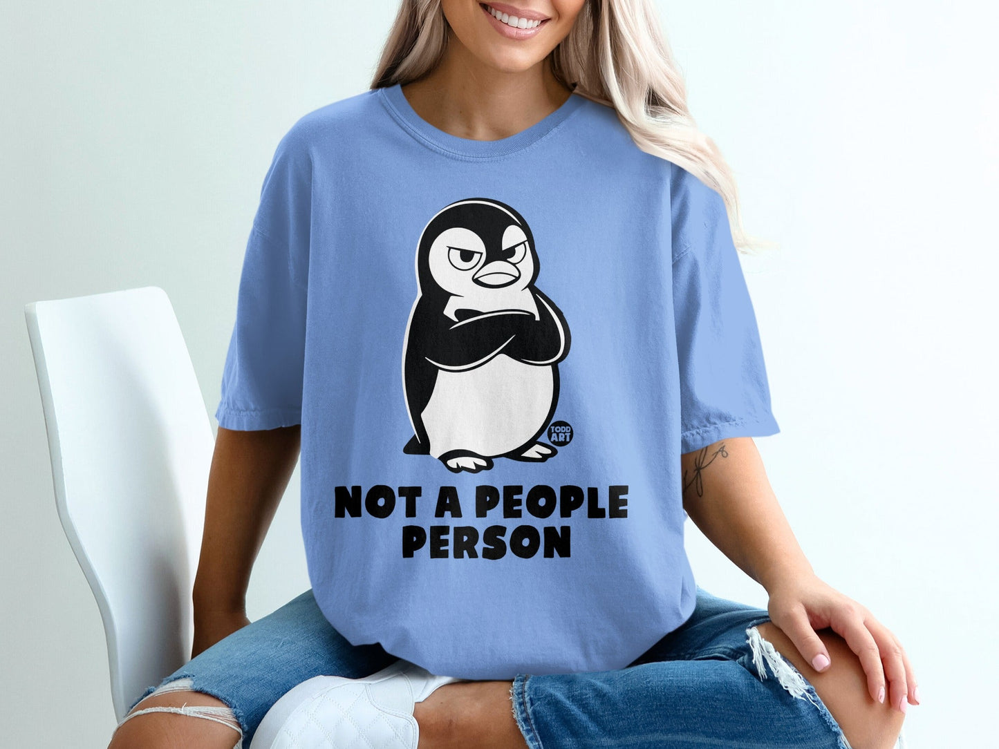 Blue t-shirt with a grumpy penguin graphic and "Not a people person" text.