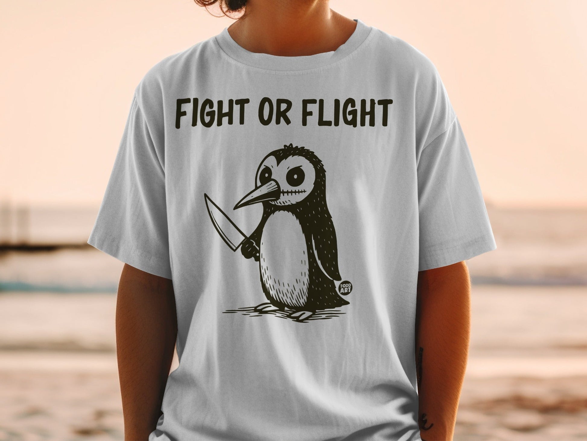 Penguin with knife and "Fight or Flight" text on a t-shirt.