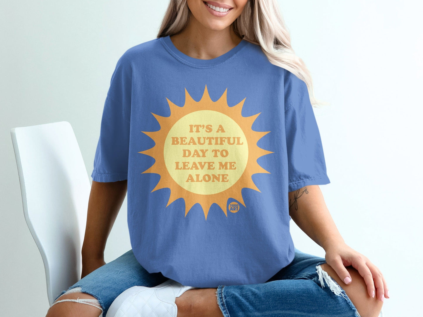 Blue t-shirt with a sun graphic and text "It's a beautiful day to leave me alone".