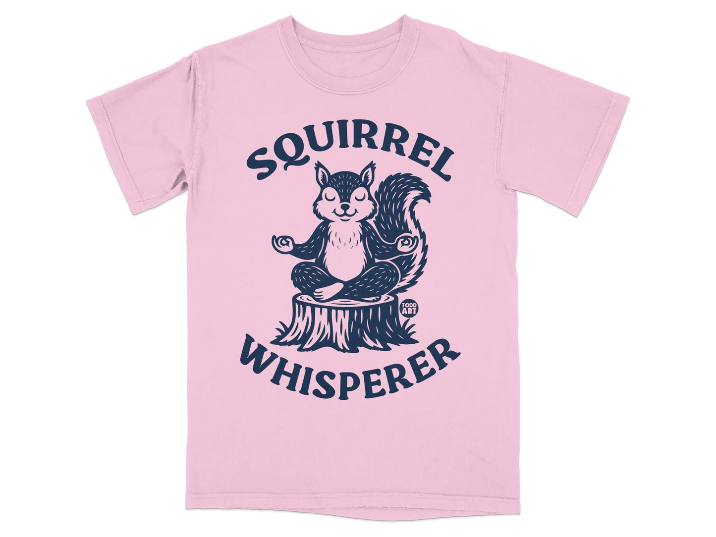 Pink t-shirt with a meditating squirrel on a tree stump, text "Squirrel Whisperer".