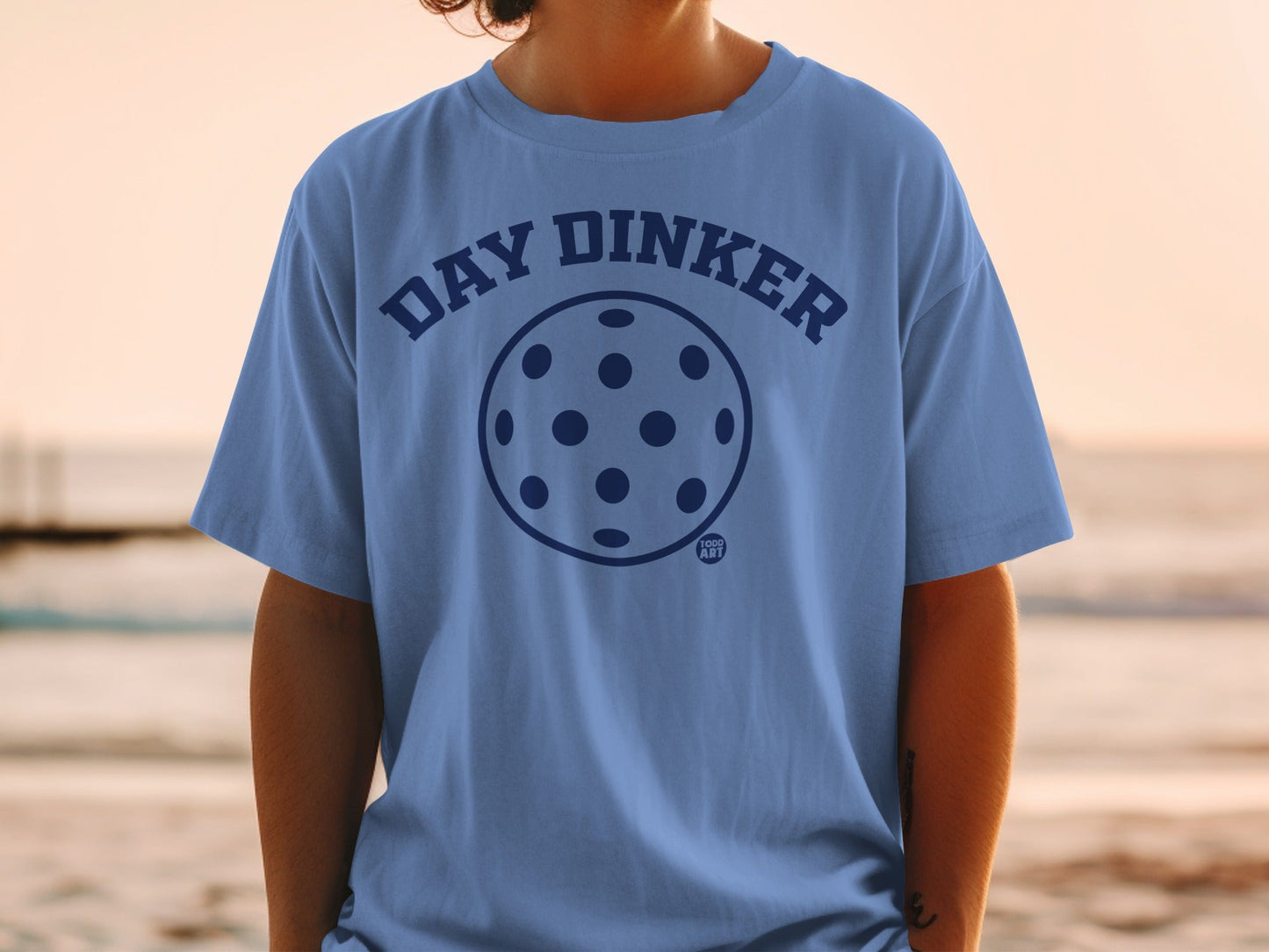 Blue t-shirt with "DAY DINKER" text and pickleball graphic.