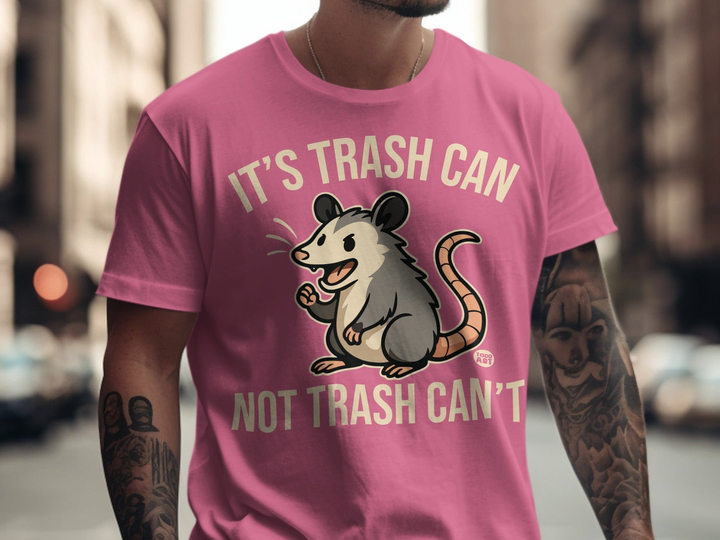 Pink t-shirt with cartoon opossum and text "It's trash can not trash can't".