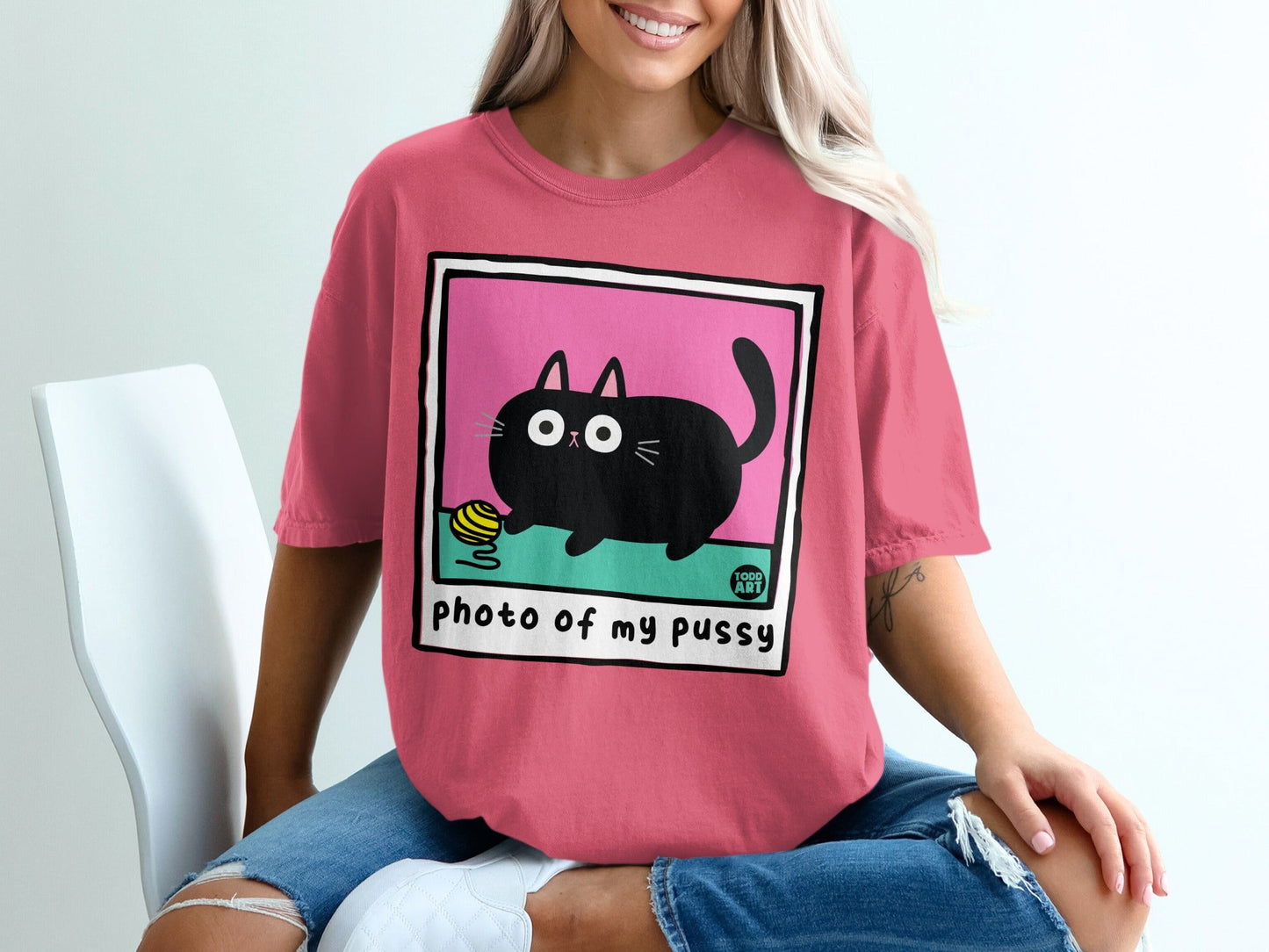 Pink t-shirt with black cat and yarn illustration and "photo of my pussy" text.