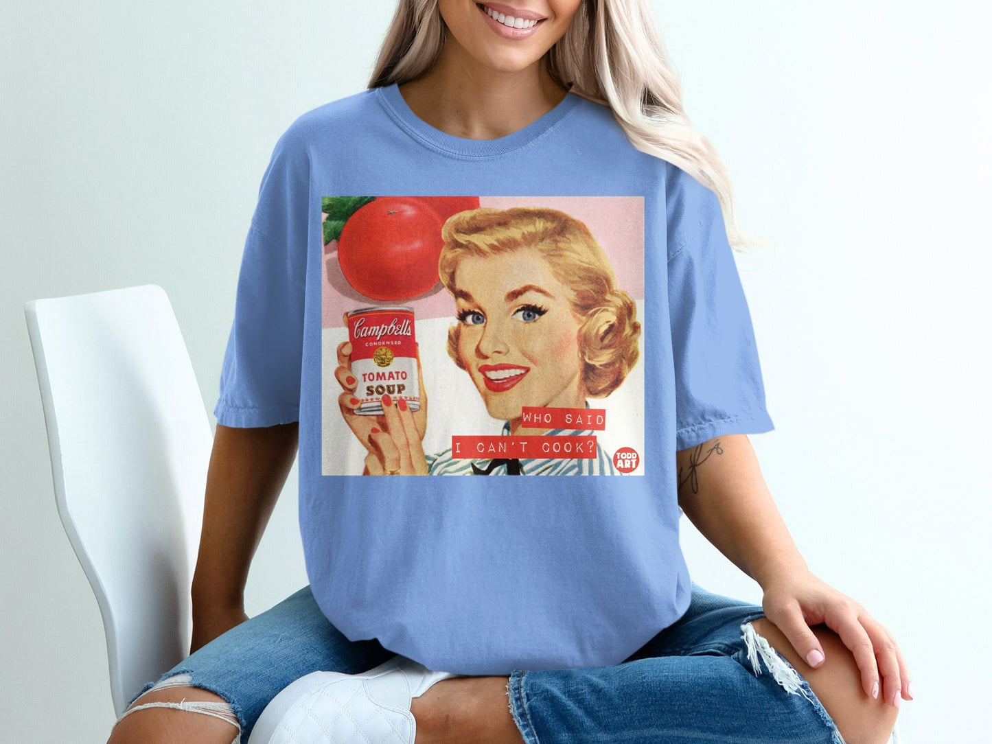Woman wearing a t-shirt with a vintage Campbell's Tomato Soup ad.