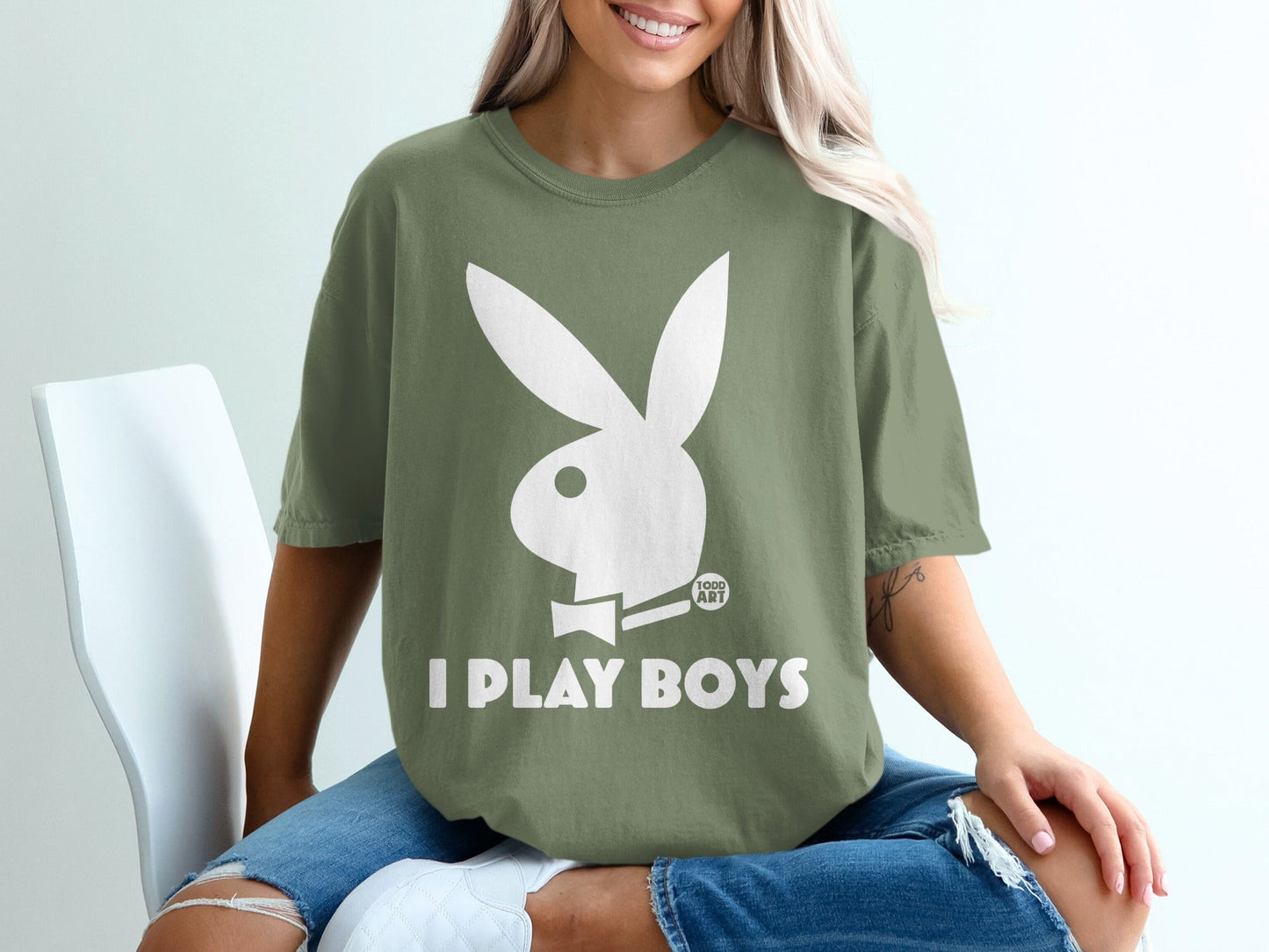 Olive green t-shirt with white Playboy bunny logo and text "I PLAY BOYS".