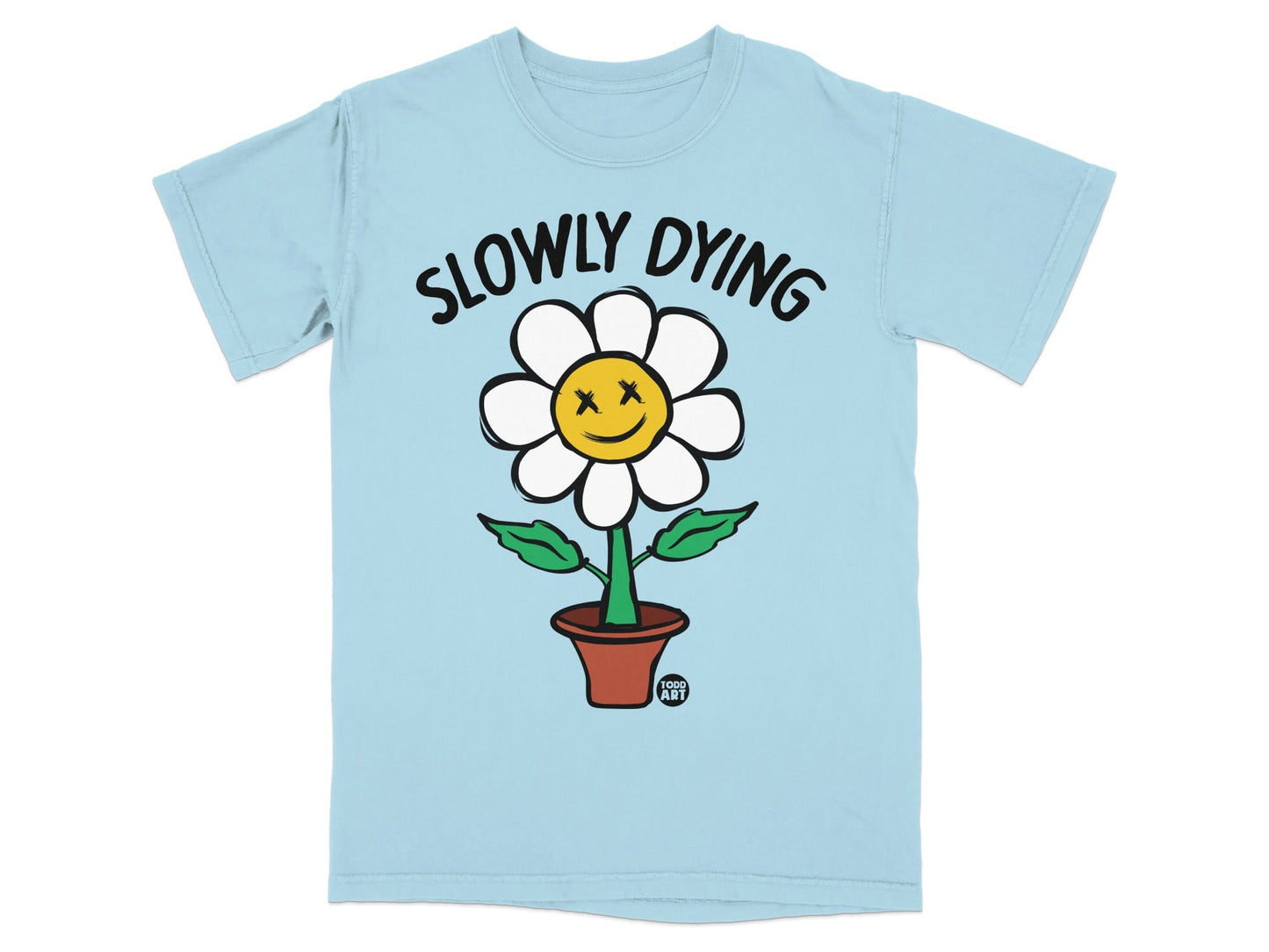 Light blue t-shirt with a cartoon flower with x's for eyes and the text "SLOWLY DYING".