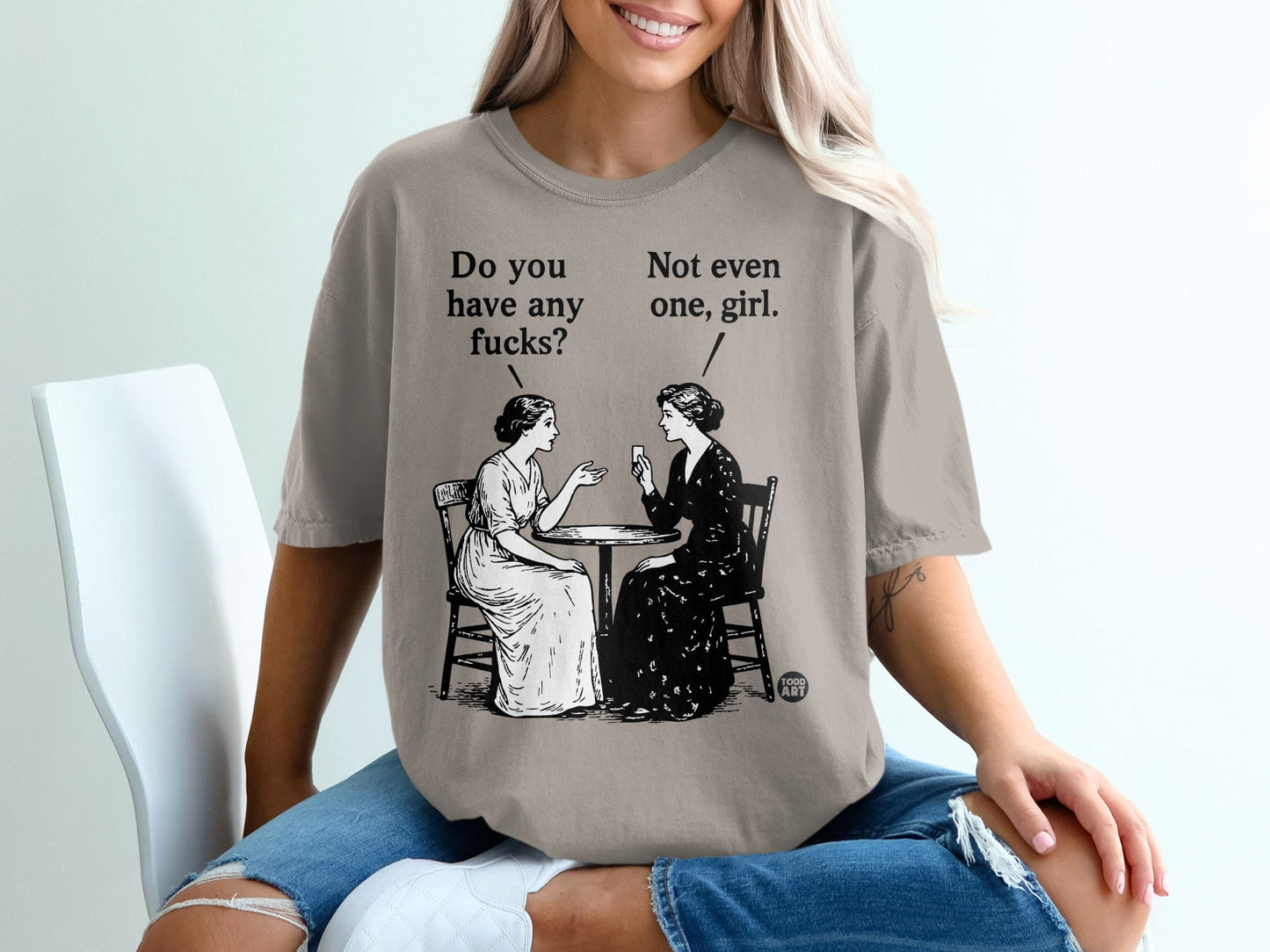 Two women at a table with text "Do you have any fucks?" and "Not even one, girl."