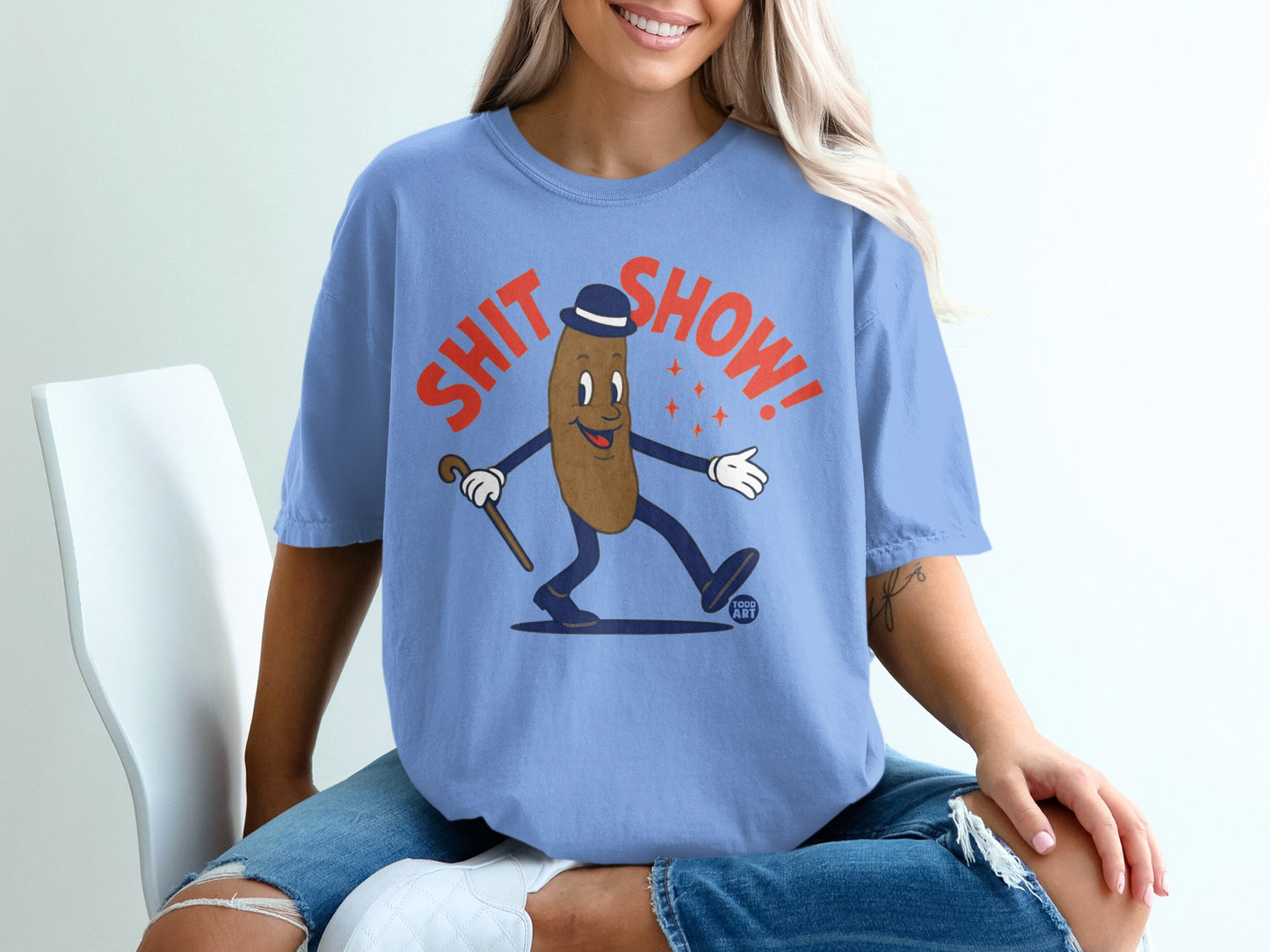 Cartoon character in a blue t-shirt with "SHIT SHOW" text and bowler hat.