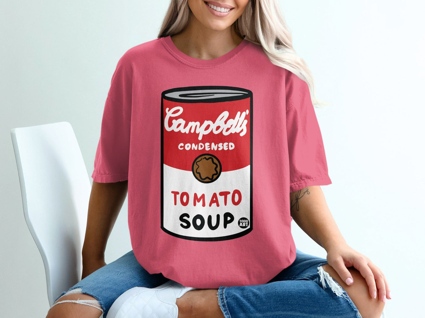 Pink t-shirt with a graphic of Campbell's Tomato Soup can.
