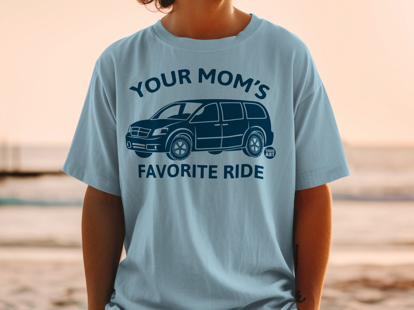Light blue t-shirt featuring a dark blue graphic of a minivan and "Your Mom's Favorite Ride" text.