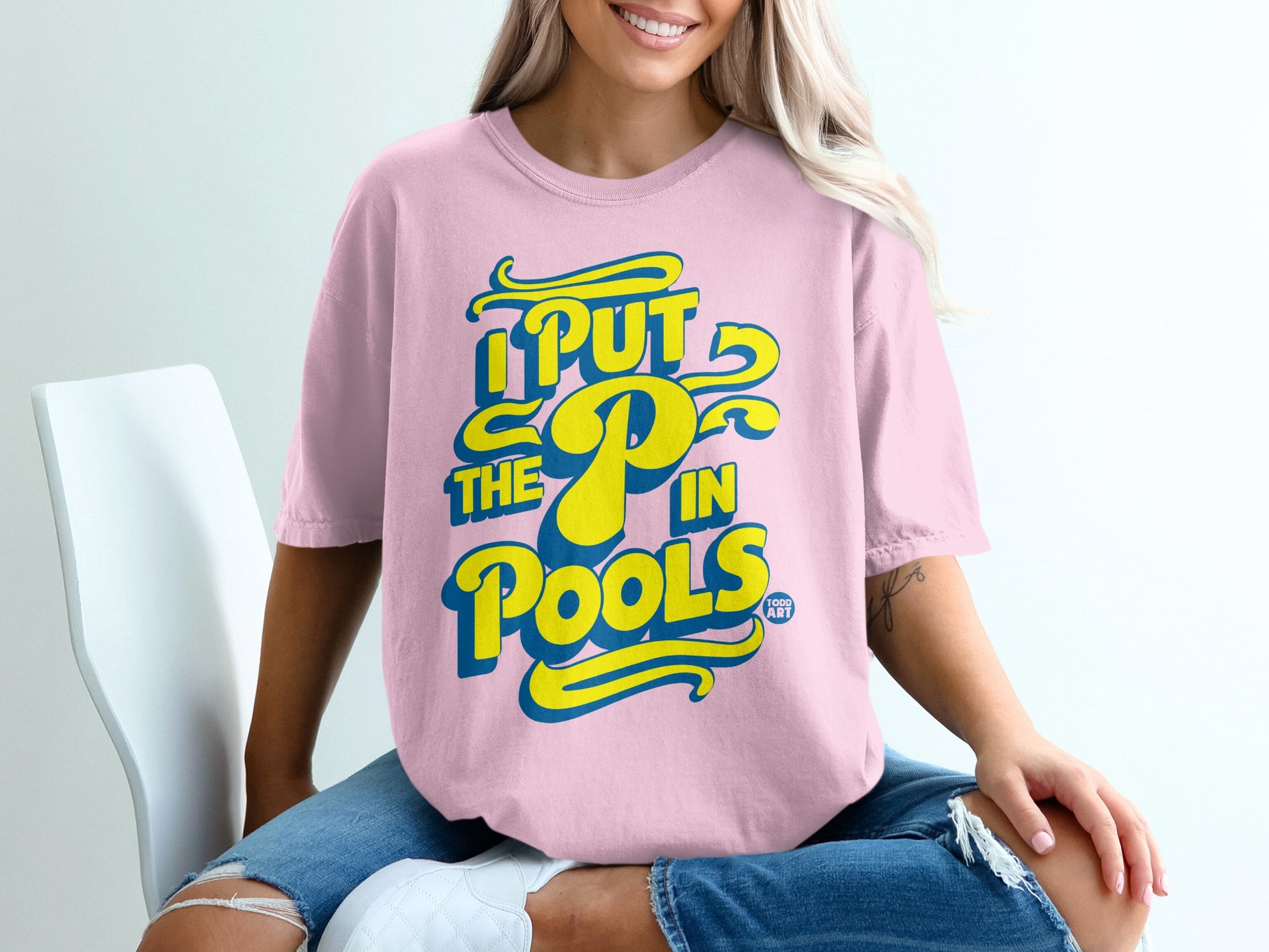 Pink t-shirt with yellow and blue text: "I PUT THE P IN POOLS".